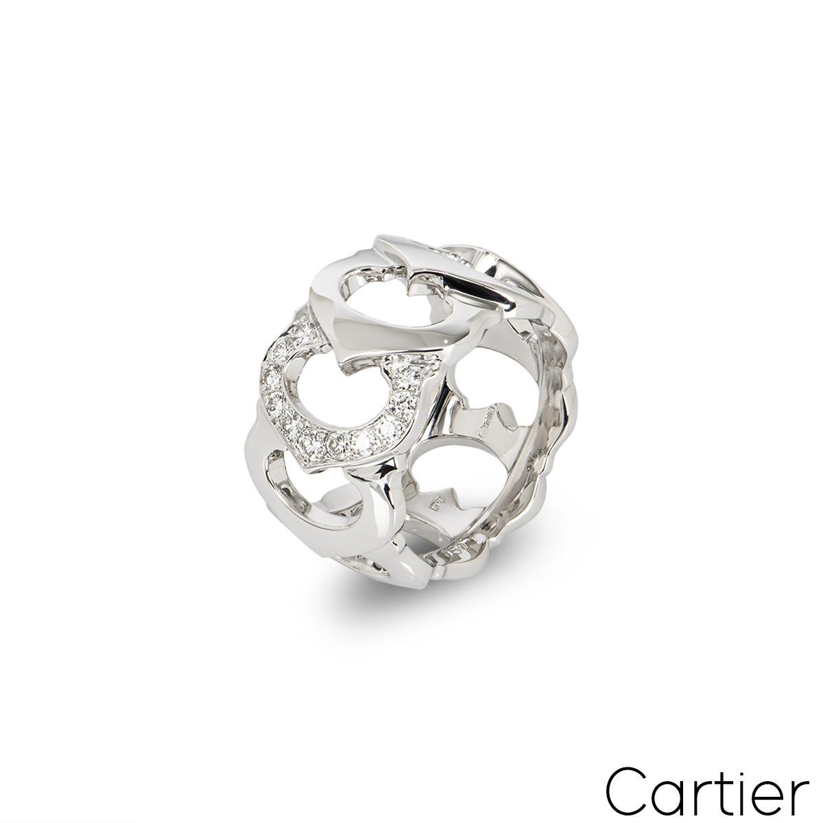 A beautiful vintage 18k white gold ring by Cartier from the C de Cartier collection. The openwork ring features 9 interlocking iconic C motifs, one pave set with 11 round brilliant cut diamonds totalling approximately 0.25ct. The ring measures