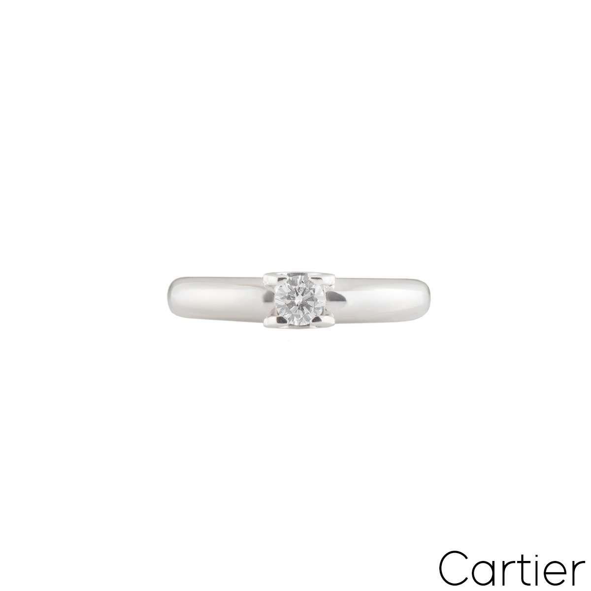 A beautiful 18k white gold diamond Cartier ring from the C de Cartier collection. The ring is set to the centre with a round brilliant cut diamond in a C de cartier motif 0.21ct, E colour and VVS2 clarity. The tapered ring measures 4mm in width and