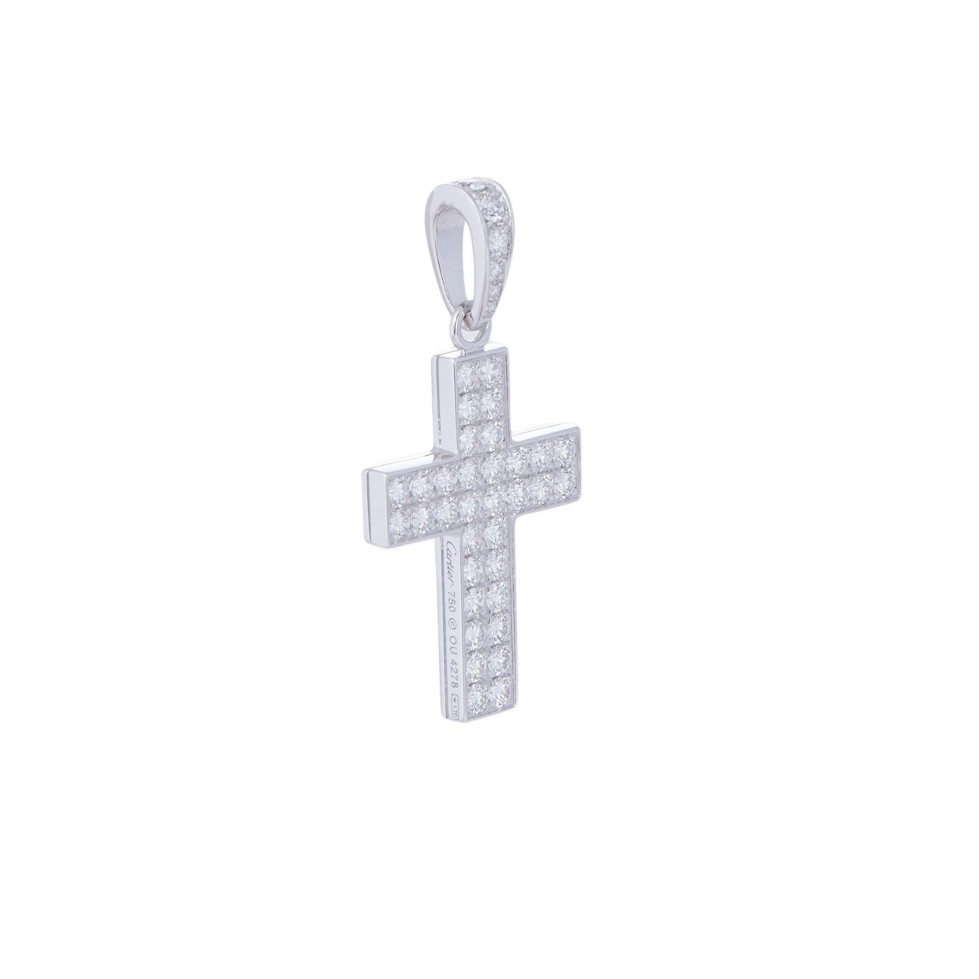 Authentic Cartier cross pendant crafted in 18 karat white gold.  The pendant is set with glittering round brilliant cut diamonds on the cross and bale for an estimated 1.75 carats total weight.  The cross measures 1 inch in length and 0.73 inches