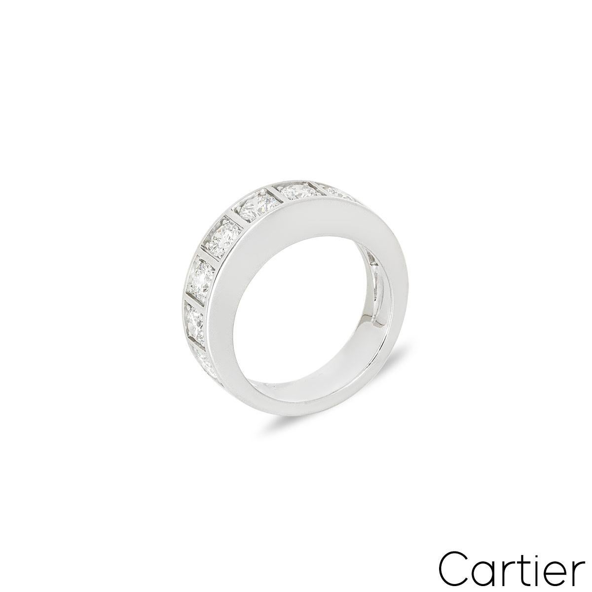 A beautiful 18k white gold half diamond set eternity ring by Cartier. The ring comprises 9 round brilliant cut claw set diamonds, each in an individual square surround. The diamonds have a total carat weight of approximately 1.35ct, are