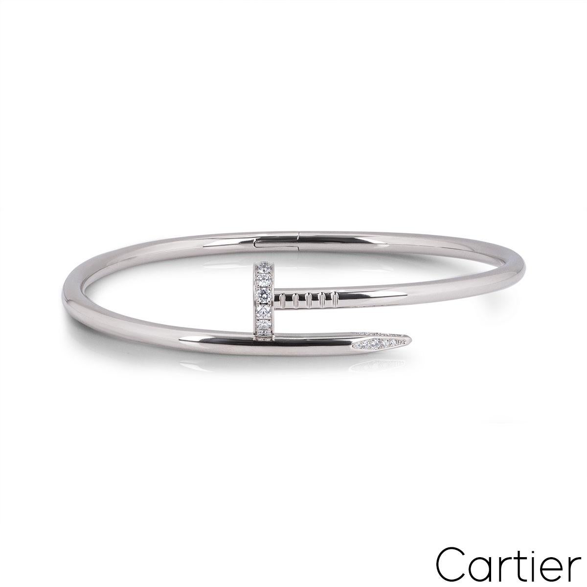 An 18k white gold and diamond bracelet by Cartier from the Juste Un Clou collection. The bangle is in the style of a nail and has 27 round brilliant cut pave diamonds set in the head and tip, totalling 0.54ct. The bangle is size 15 and features the