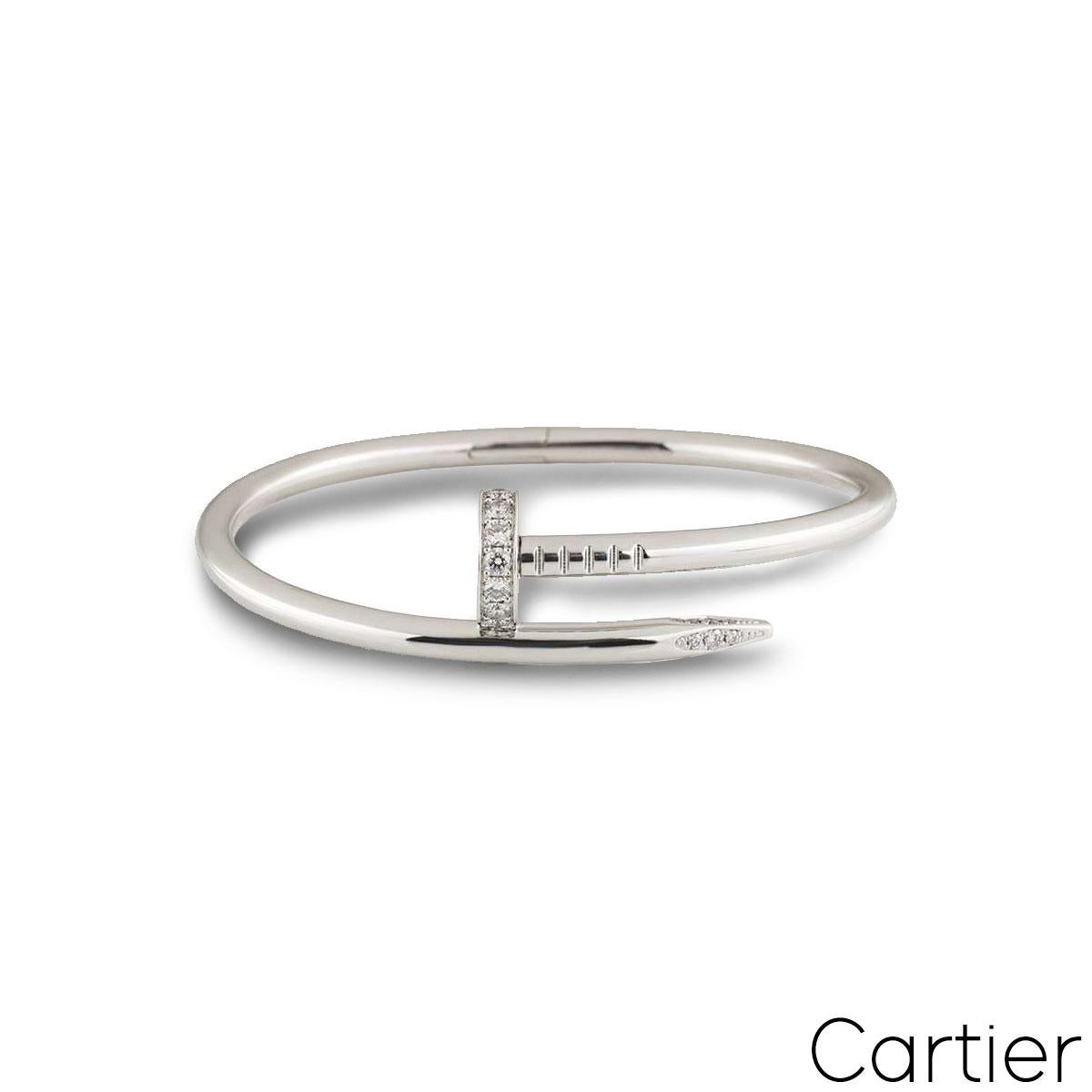 An 18k white gold and diamond bracelet by Cartier from the Juste un Clou collection. The bangle is in the style of a nail and has 27 round brilliant cut diamonds pave set in the head and tip, totalling 0.54ct. A size 15 and featuring the old style