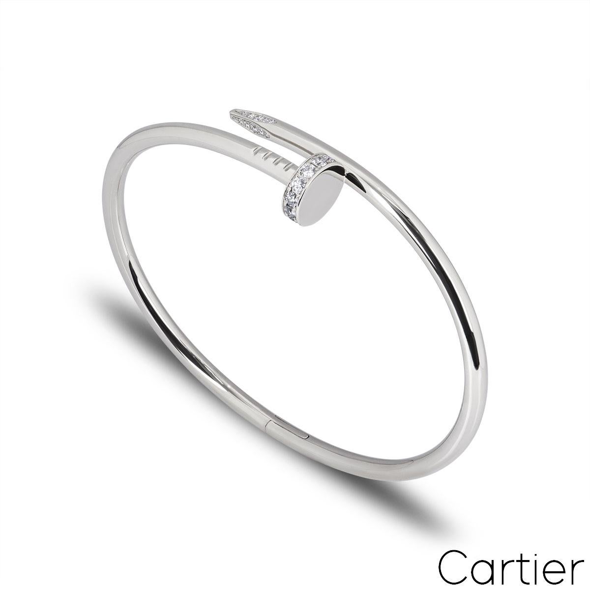 An 18k white gold diamond bracelet by Cartier from the Juste Un Clou collection. The bracelet is in the style of a nail and has 27 round brilliant cut pave diamonds set in the head and tip, totalling 0.54ct. The diamonds are predominantly F colour
