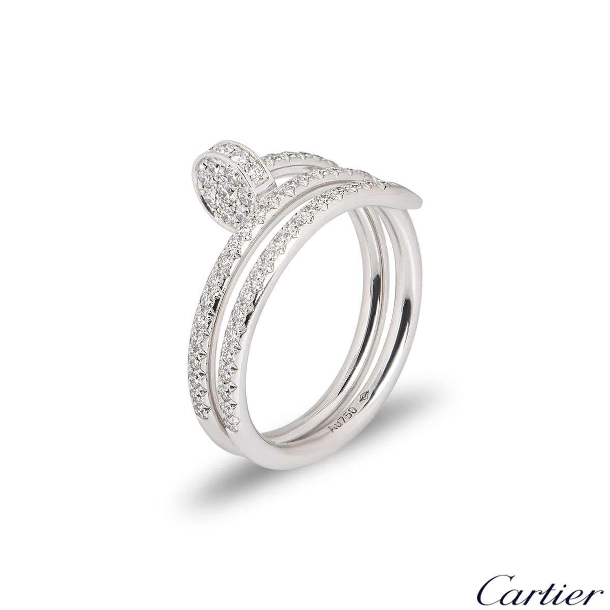 An 18k white gold double Juste Un Clou ring by Cartier. The ring is in the style of a nail wrapping around the finger, set with round brilliant cut diamonds to the front sections. There are 77 diamonds with a total diamond weight of 0.59ct. The ring