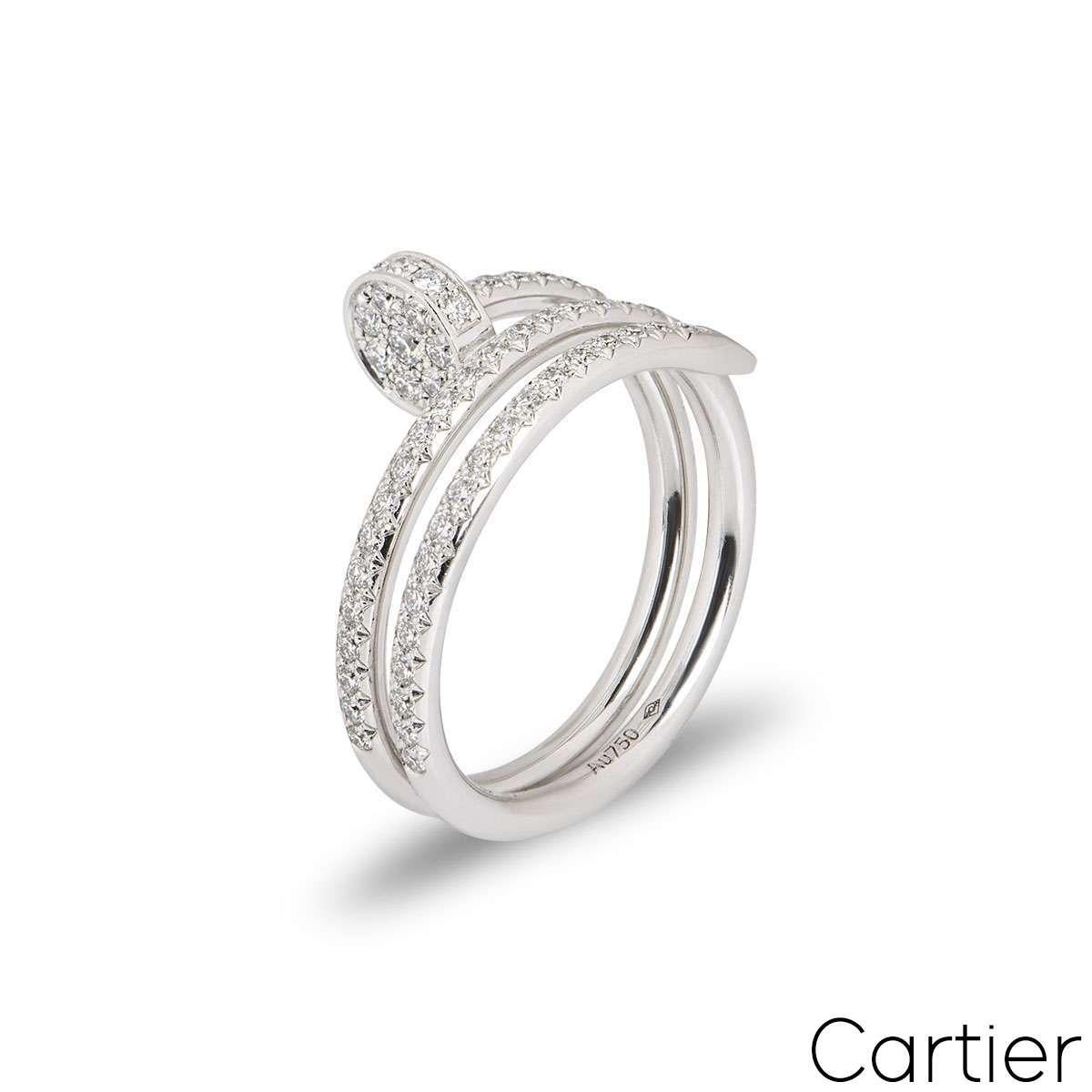 An 18k white gold double Juste un Clou ring by Cartier. The ring is in the style of a nail wrapping around the finger, set with round brilliant cut diamonds. There are 77 diamonds with a total diamond weight of 0.59ct. The is a UK size R 1/2/ US
