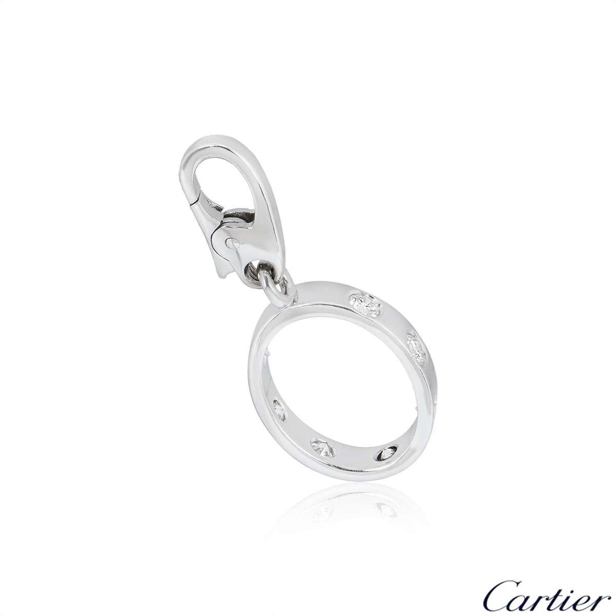 An 18k white gold Love charm by Cartier. The oval shape charm features 7 round brilliant cut diamonds set around the outer edge, totalling approximately 0.30ct. The charm measures 2.5cm in length and has an original lobster clasp. The charm has a