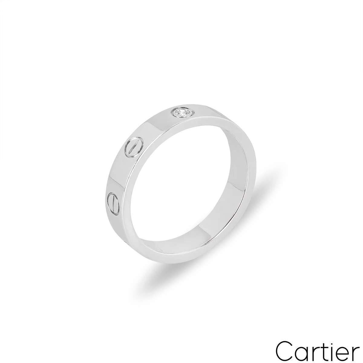Une alliance en diamants de Cartier en or blanc de la collection Love. La bague comprend les vis emblématiques de Cartier et un seul diamant rond de taille brillant serti au centre, d'une valeur totale de 0,02ct. Mesurant 4 mm de largeur, cette