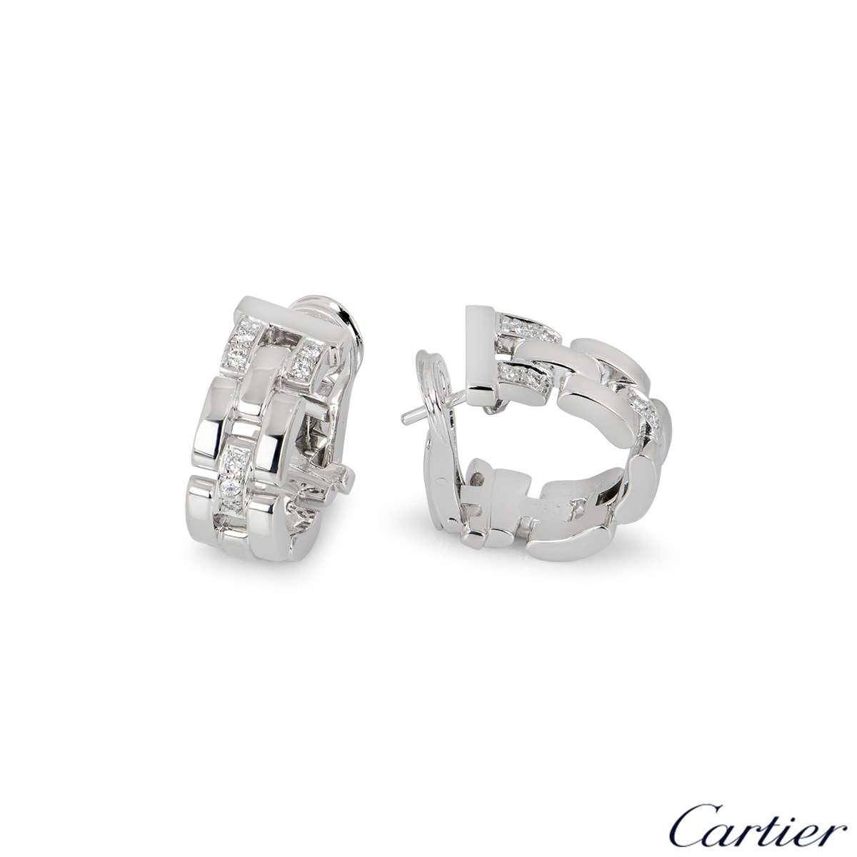 A pair of 18k white gold Maillon Panthere earrings by Cartier. Each hoop style earring is made up of iconic flat white gold solid links with 3 pave set diamond intersections, totalling approximately 0.20ct. The earrings have posts and lever hinge