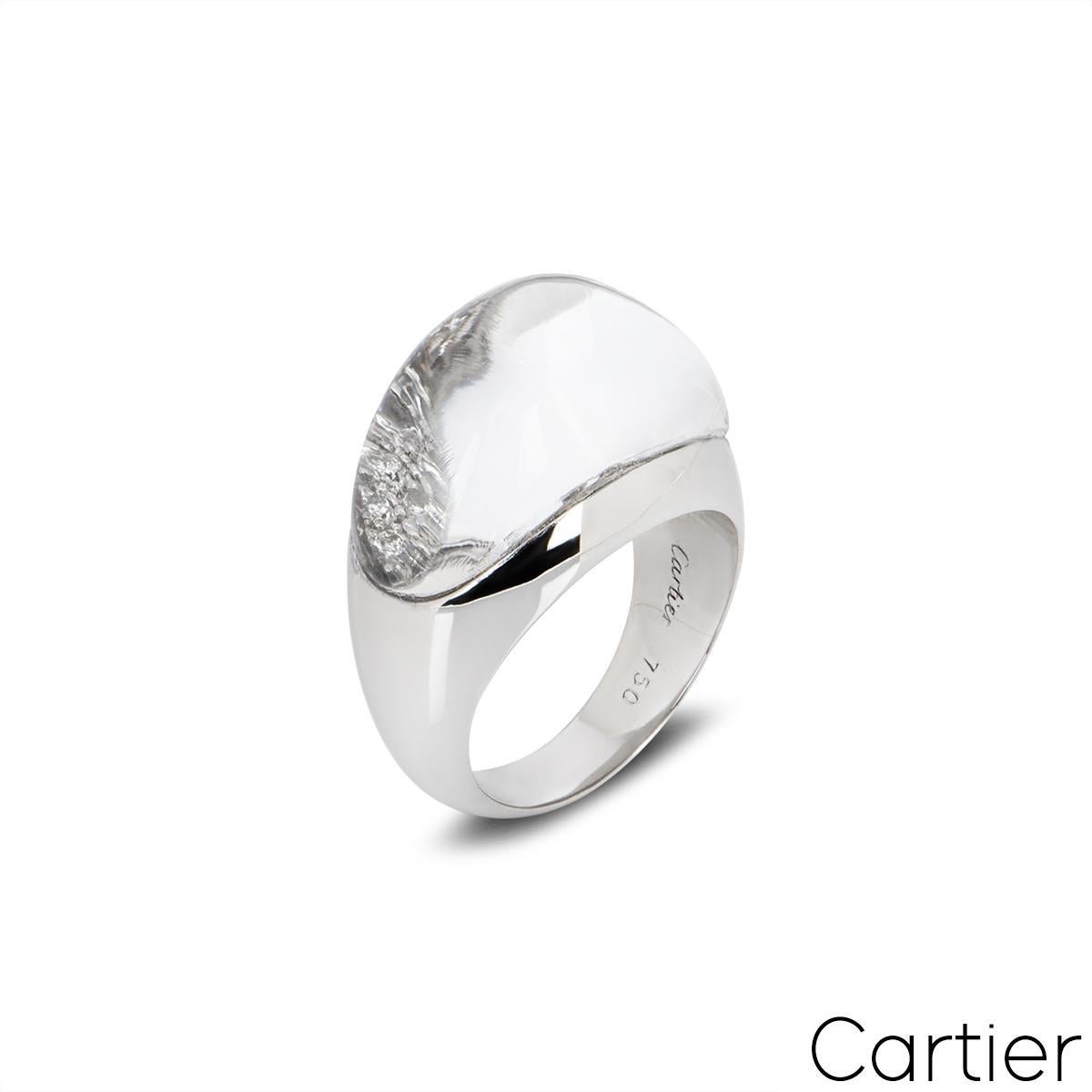 An exquisite 18k white gold diamond ring by Cartier from the Myst de Cartier collection. The ring features 25 round brilliant cut diamonds under a domed rock crystal overlay. The ring measures 14mm wide and tapers down to 4.8mm, is a UK size M and