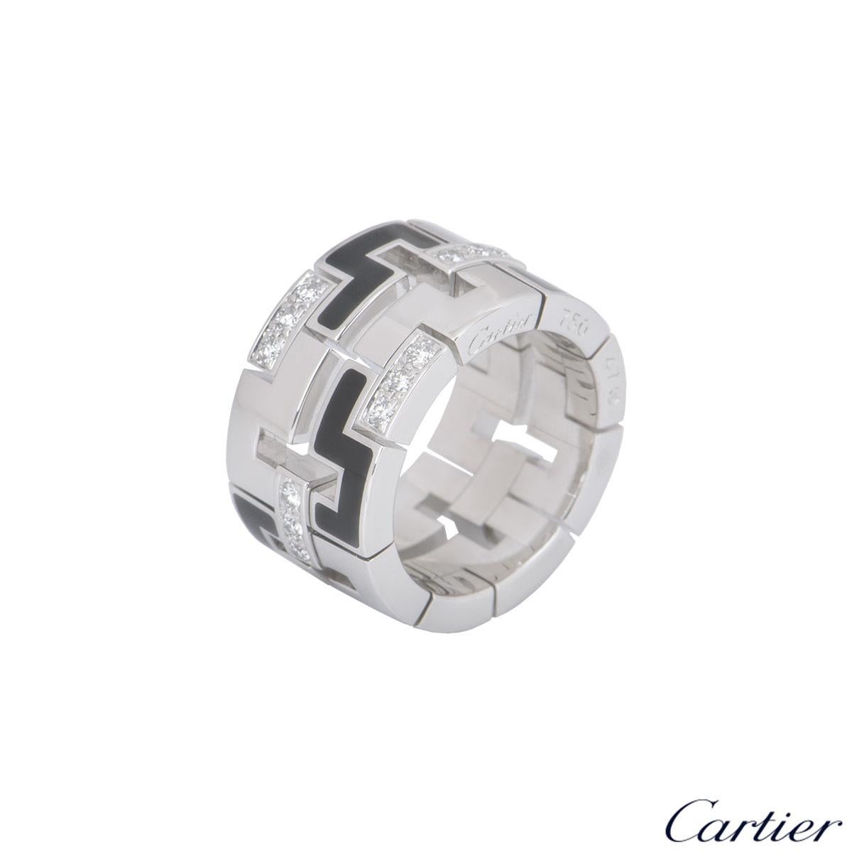 An 18k white gold diamond and enamel ring by Cartier from the Le Baiser Du Dragon collection. The square abstract design alternates with polished, black enamel and round brilliant cut diamond set links. There are 27 round brilliant cut diamonds with