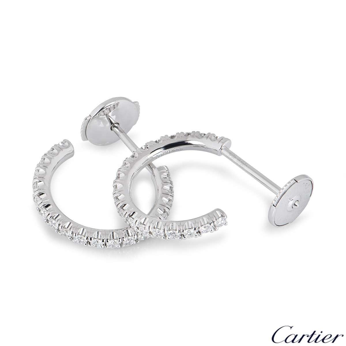 A pair of 18k white gold hoop earrings from the Etincelle de Cartier collection. Each earring is set with 19 round brilliant cut diamonds with a total weight of 0.13ct. The earrings measure 1.4cm in diameter and feature posts with alpha back