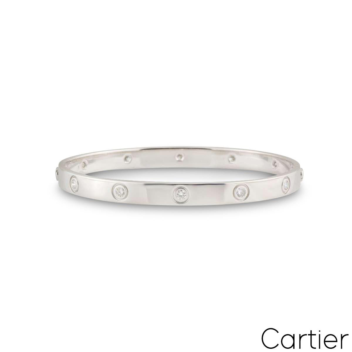 An 18k white gold full diamond Cartier bracelet from the Love collection. The bracelet is set with 10 round brilliant cut diamonds circulating the outer edge throughout in a rubover setting. The bracelet is size 17 and features the old style screw