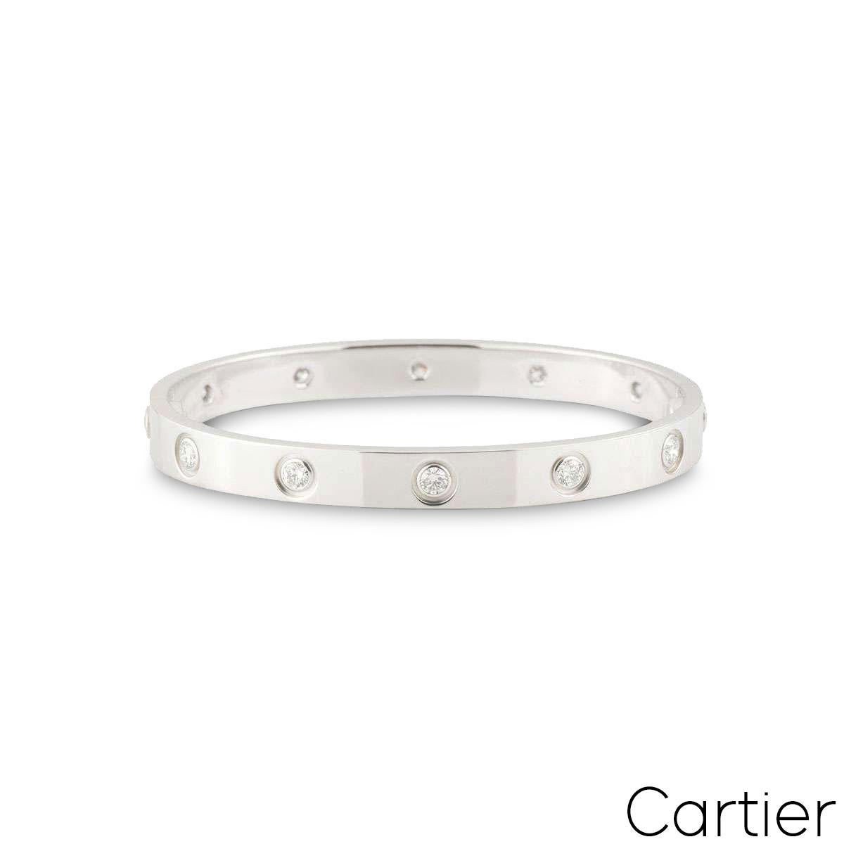 An 18k white gold full diamond Cartier bracelet from the Love collection. The bracelet is set with 10 round brilliant cut diamonds circulating the outer edge throughout in a rubover setting. The bracelet is size 17 and features the new style screw