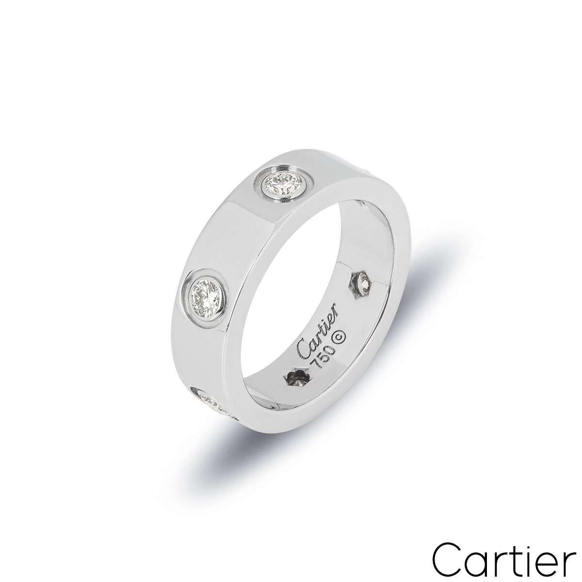 An iconic 18k white gold Cartier ring from the Love collection. The ring comprises of 6 round brilliant cut diamonds set throughout the centre of the band. Measuring 5.5mm in width, with a gross weight of 8.57 grams, this ring is a size UK N½ - EU