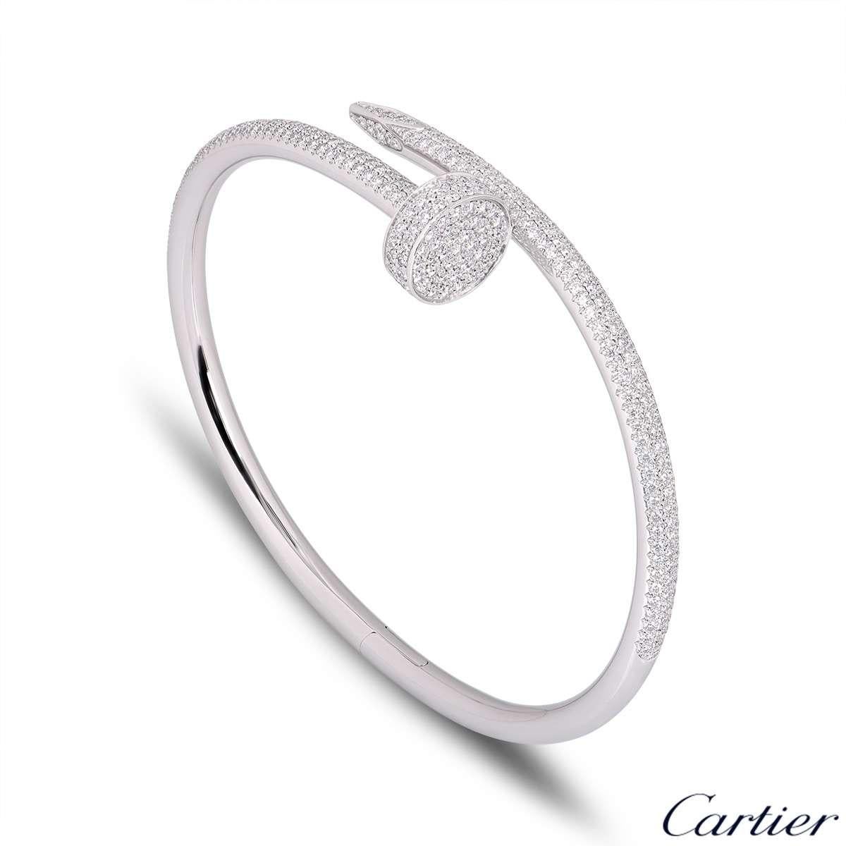 A stunning 18k white gold diamond bangle by Cartier from the Juste Un Clou collection. The bangle is of a nail design, fully pave set around the outer side with 374 round brilliant cut diamonds totalling 2.26ct. The bangle is a size 17 and has the