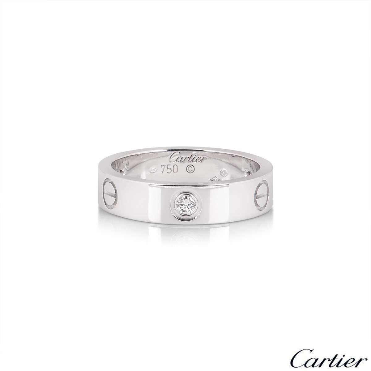 An 18k white gold ring from the iconic Love collection by Cartier B4032500. The ring is set with 3 round brilliant cut diamonds in a rub-over setting totalling 0.22ct, alternating between the iconic screw motif through the centre of the band. The