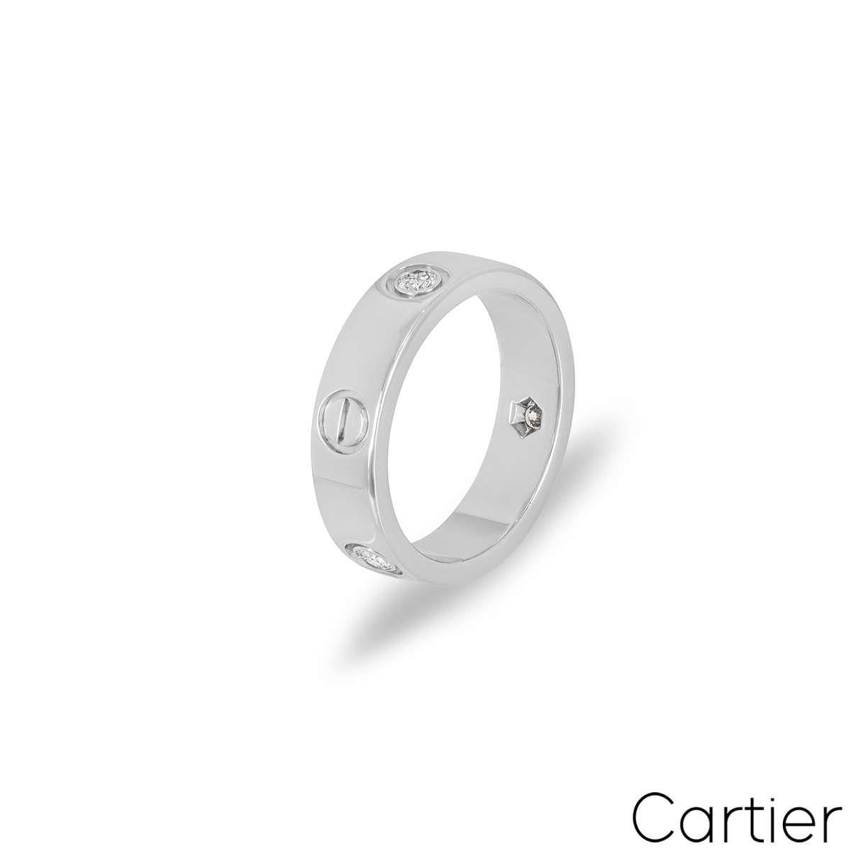 A signature 18k white gold ring from the Love collection by Cartier. Set with 3 round brilliant cut diamonds totalling 0.22ct, alternating between the iconic Cartier screw motifs. 5.5mm wide, the ring is a size UK M - EU 52 and has a gross weight of