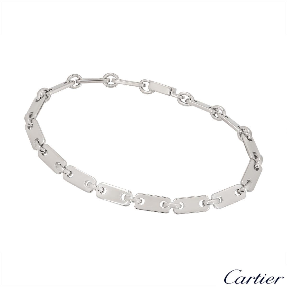 An elegant 18k white gold rectangular link bracelet by Cartier. The bracelet comprises 15 rectangular plain pierced links and alternating between each link is a round circular link. The bracelet measures 7.5 inches in length and features a open
