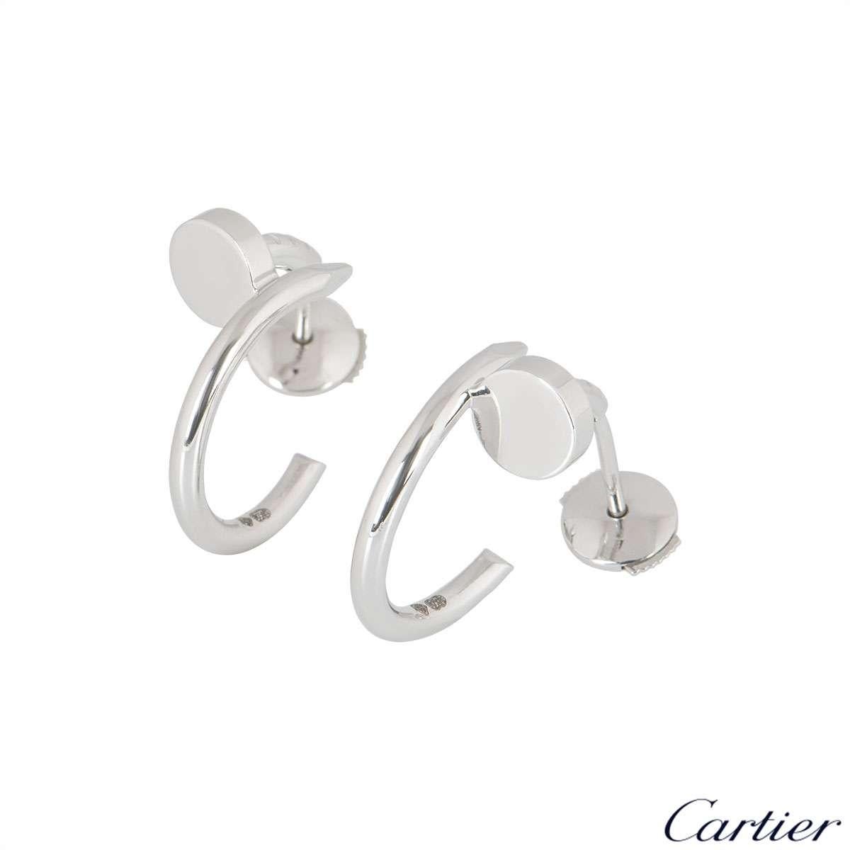 A pair of 18k white gold earrings from the Juste un Clou collection by Cartier. The earrings are styled as a nail wrapping around the earlobe. The earrings measure 1.5cm in diameter and feature post and alpha back fittings, with a gross weight of