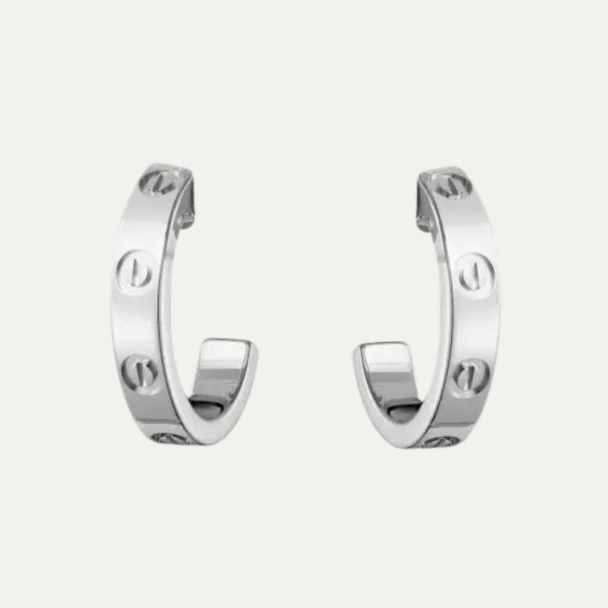 Cartier’s iconic Love motif is reimagined in these sleek white gold half hoop earrings. 

18K white gold 
Signed Cartier, numbered XH1435 
Accompanied by Cartier box 