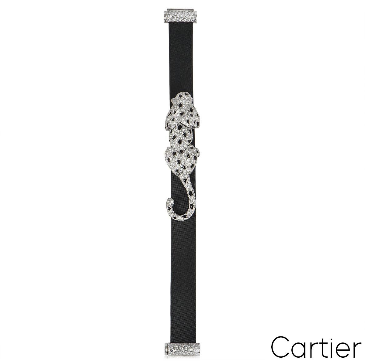 An exceptional Cartier 18k white gold diamond, onyx and emerald bracelet from the Panthere de Cartier collection. The bracelet features the iconic panther motif set with 2 pear shaped emerald eyes, 54 onyx spots and 581 pave set round brilliant cut