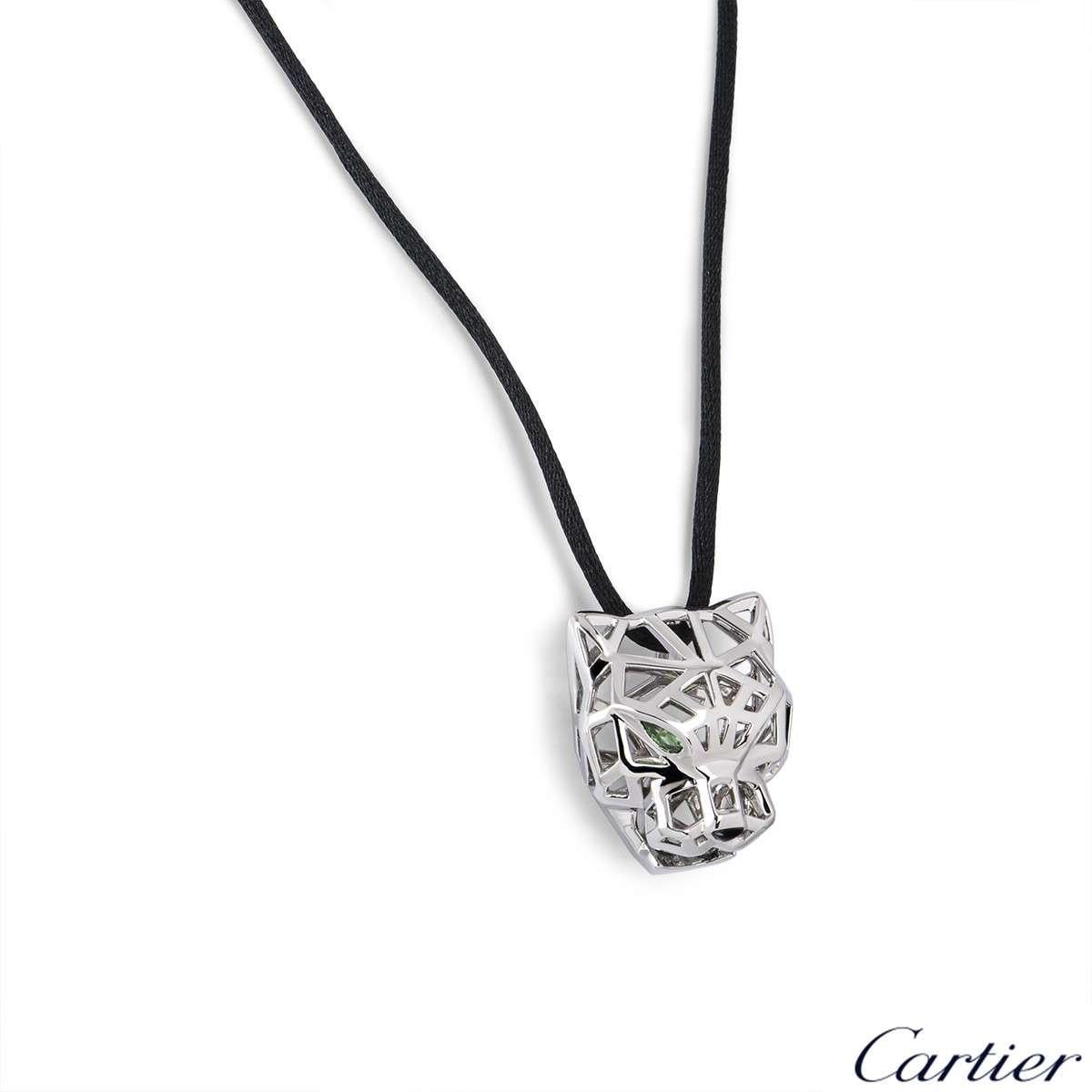 An 18k white gold Panthere de Cartier necklace. The motif is designed as an openwork Panthere head, with tsavorite garnets for the eyes and onyx for the nose. The motif measures 2.7cm in width and 3cm in length. The motif comes on an adjustable 25