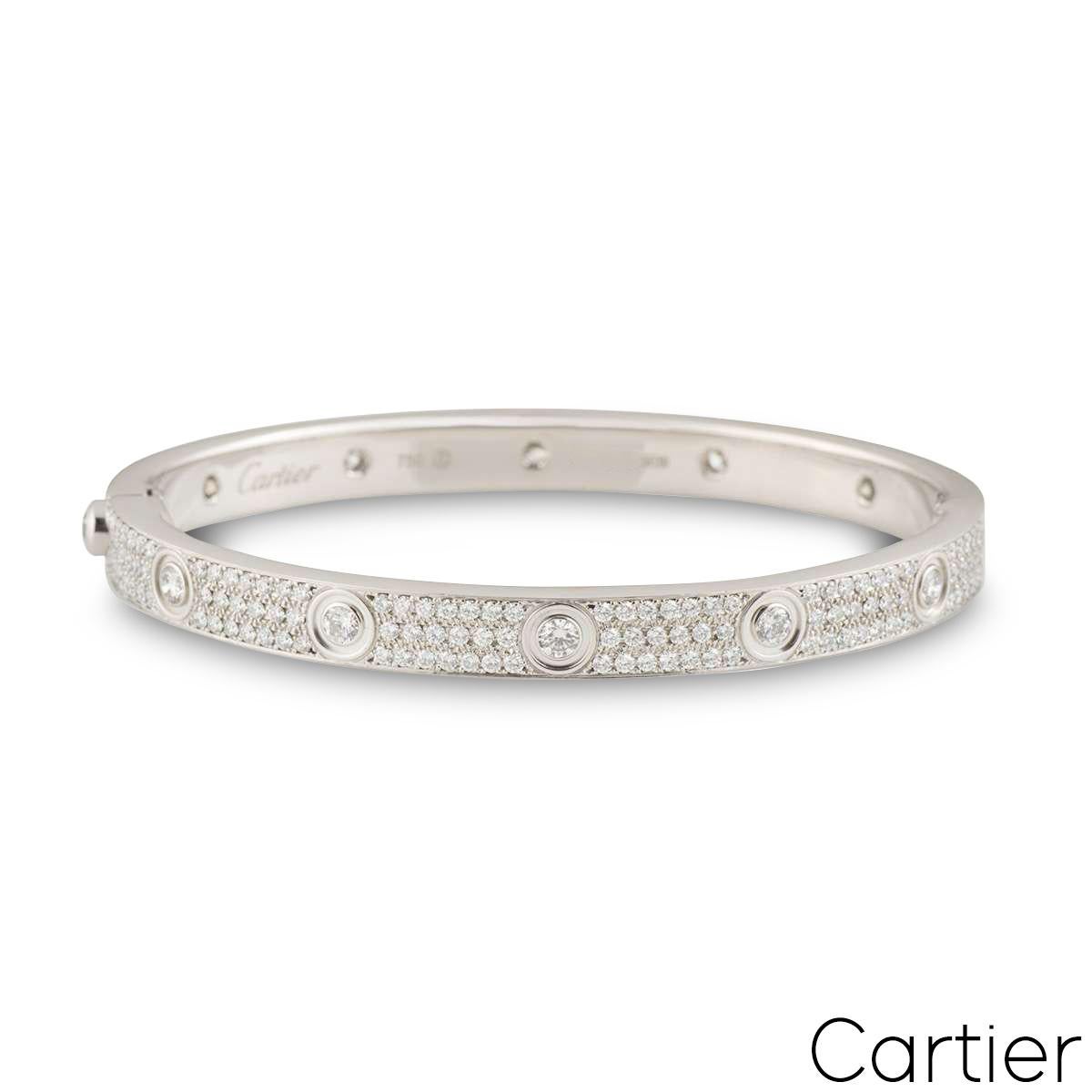An amazing 18k white gold diamond bracelet by Cartier, from the Love collection. The bracelet has 12 round brilliant cut diamonds around the outer edge and 216 round brilliant cut diamonds pave set between the iconic screw motif design, with an