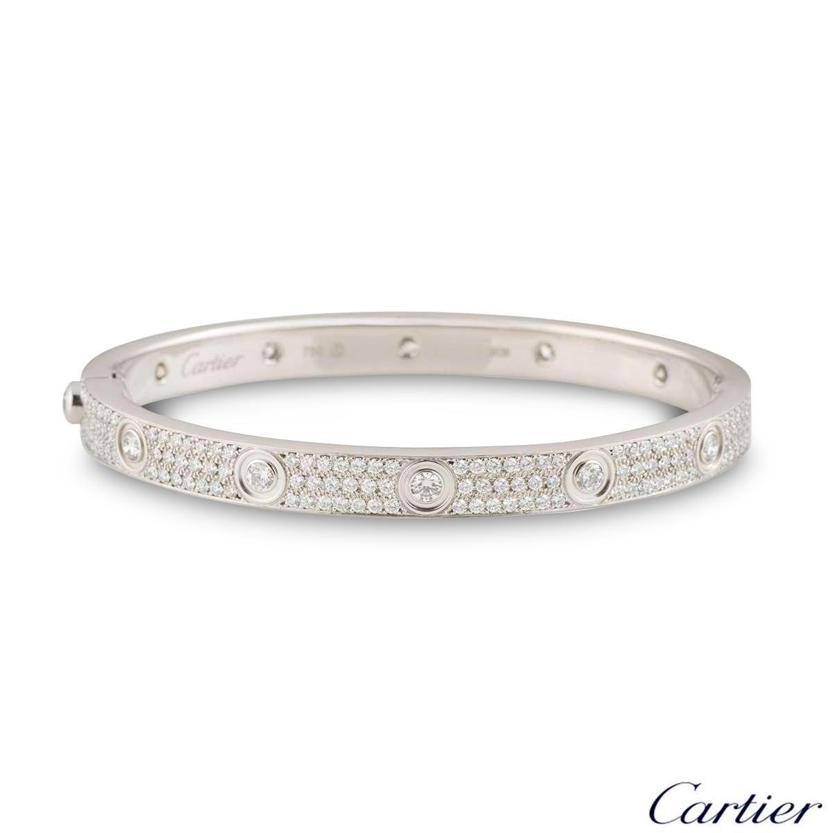 A sparkly 18k white gold Cartier diamond bracelet from the Love collection. The bracelet has the 10 round brilliant cut diamonds around the outer edge in a rubover setting with 204 round brilliant cut diamonds pave set between each screw motif. The