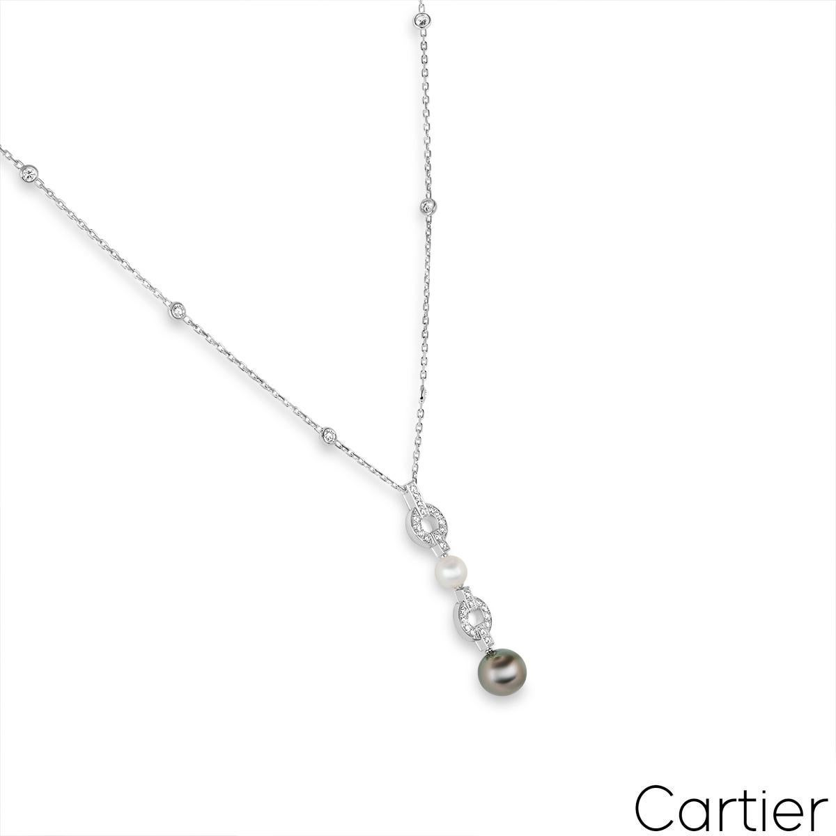 A beautiful 18k white gold pearl and diamond necklace by Cartier from the Himalia collection. The pendant alternates between a diamond set circular motif and a pearl. The first pearl measures 7mm in width and displays a white hue with a silvery-pink