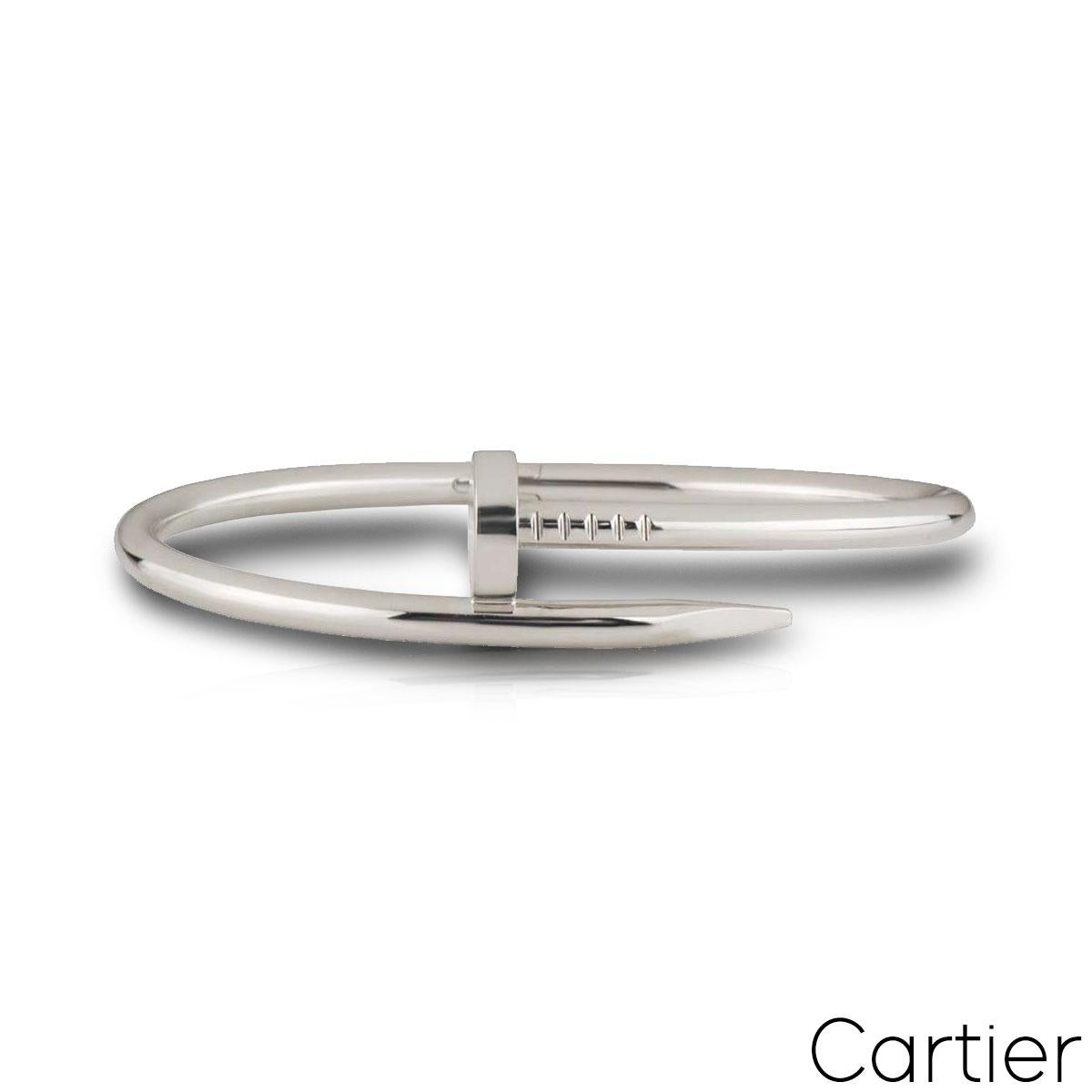 An iconic 18k white gold Cartier bracelet from the Juste un Clou collection. The bracelet is wrapped around with a nail head at one end and nail end at the other. The bracelet features the old clasp and is size 15 with a gross weight of 31.00