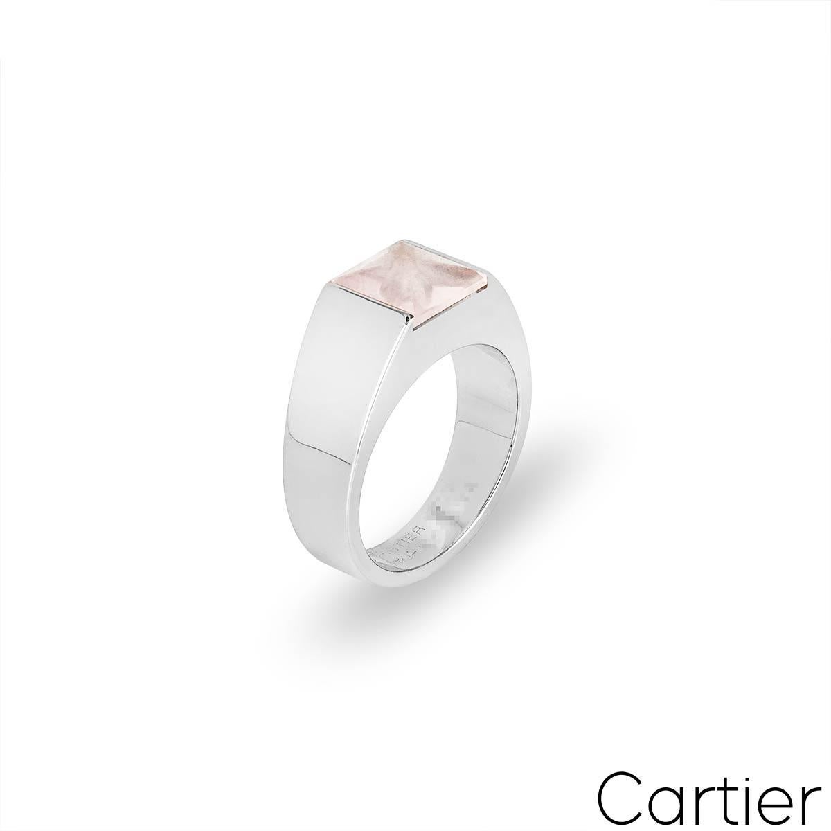 An 18k white gold ring from the Tank collection by Cartier. The ring is set to the centre with a square cut rose quartz in a tension setting. The ring measures 8mm in width tapering to 5mm, is a UK size N/ US size 7/ EU size 53 and has a gross