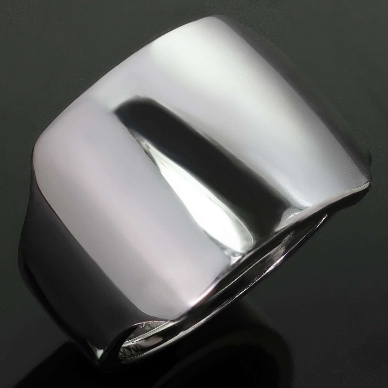 This elegant Cartier ring features a stylishh wide design crafted in 18k white gold. Made in France circa 1990s. Measurements: 0.59