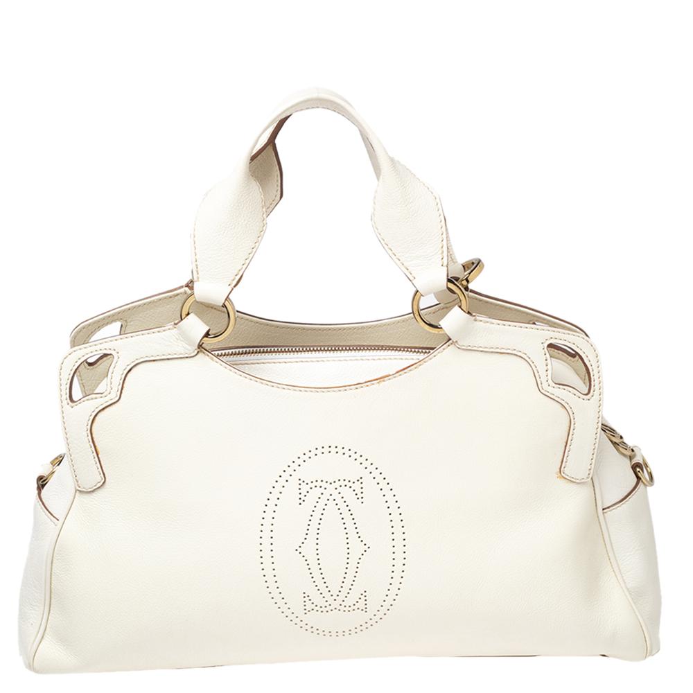 This Cartier beauty arrives in a gorgeous shape and design. It has a leather body with the logo detailed on the exterior and is held by two handles. The zipper secures the fabric interior and overall, the bag looks ready to lift your classic