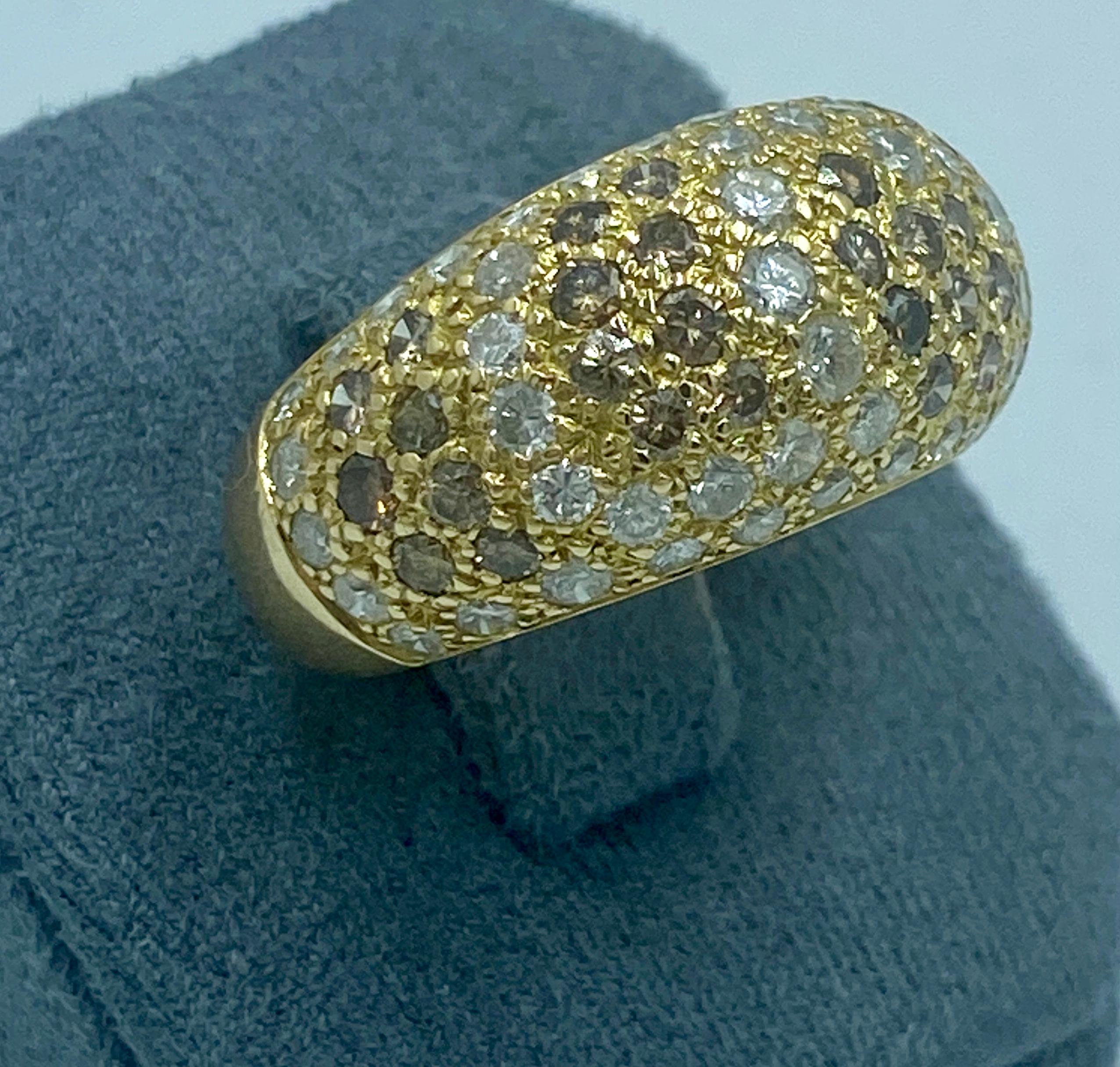 This striking 1990s Cartier bombe ring contains a total of approximately 3 carats of white, light yellow and mixed brown fancy round cut diamonds. Made in France, it is a US size 8 and can be resized.