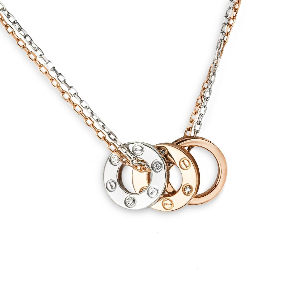 A delicate white and rose gold necklace from the Cartier Love collection. The necklace features a double strand chain, one in rose gold and the other in white gold. Featuring three love motifs which illustrate the iconic Love screws, as well as 6