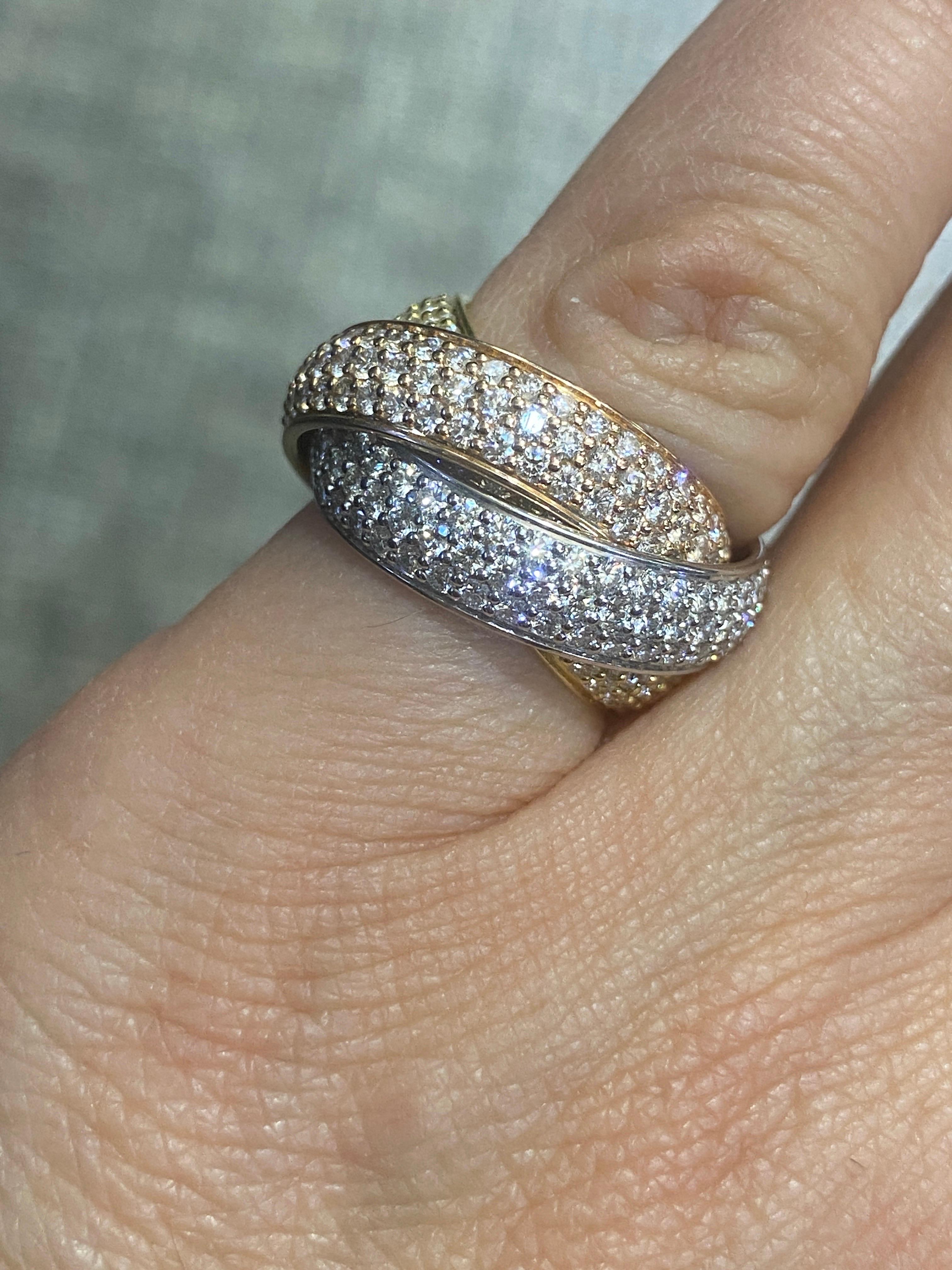 This beautiful wide diamond pave Trinity ring in white, yellow and rose gold is a Cartier classic dating circa 1980s. It is a small size suitable for slim fingers or to be worn as a pinky ring.