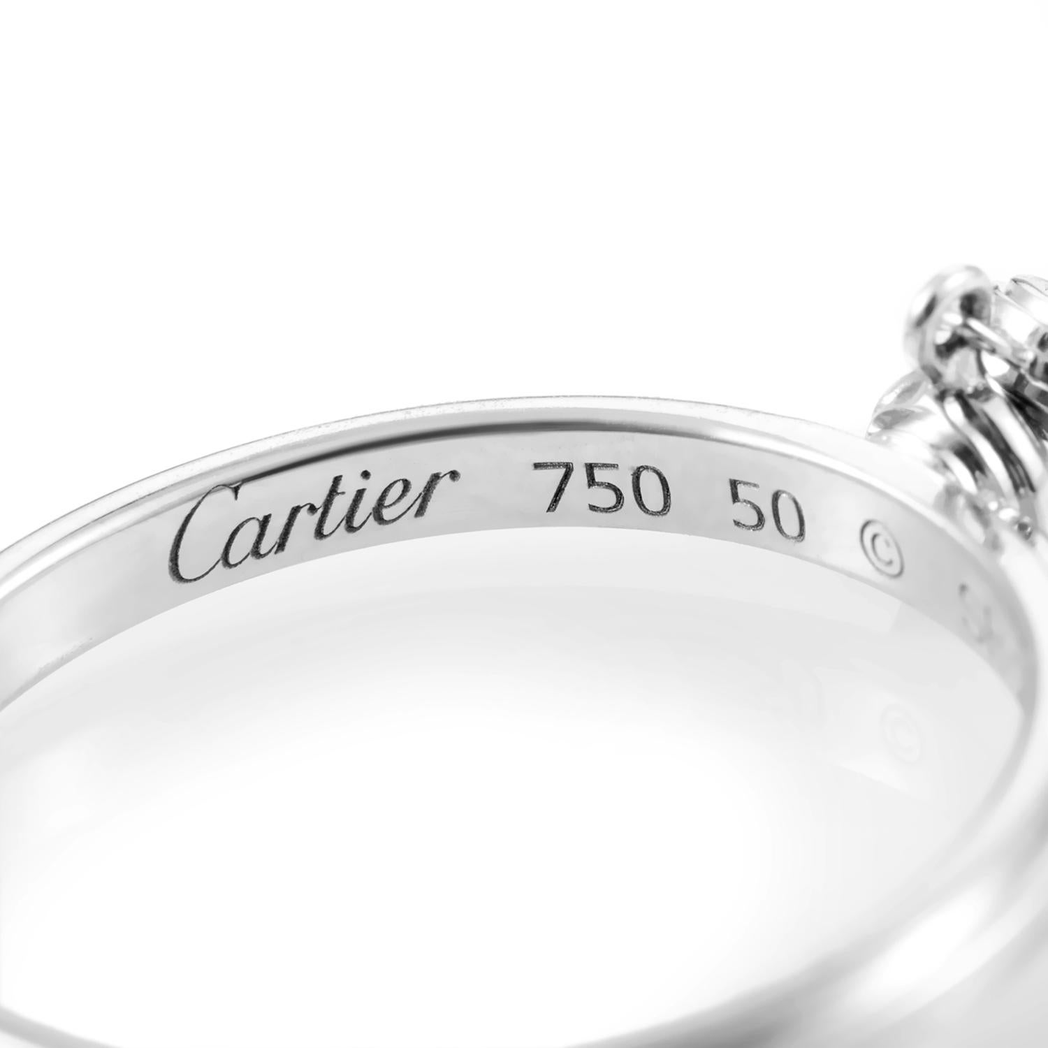 Applying an intriguing twist to an elegant design, Cartier attached an additional charm adorned with a nifty diamond that brings the total to 0.12ct of bright glisten in this splendid ring made of untarnished 18K white gold.
