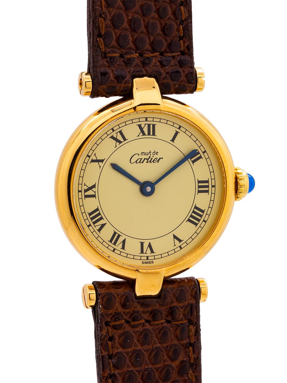 
Cartier women’s vermeil Vendome Tank wristwatch circa 1990s. Case mesuring 24 x 31mm with T-bar lugs. Featuring an original cream dial with classic printed Cartier Roman numbers, signed must de Cartier, with blued steel hands and blue sapphire