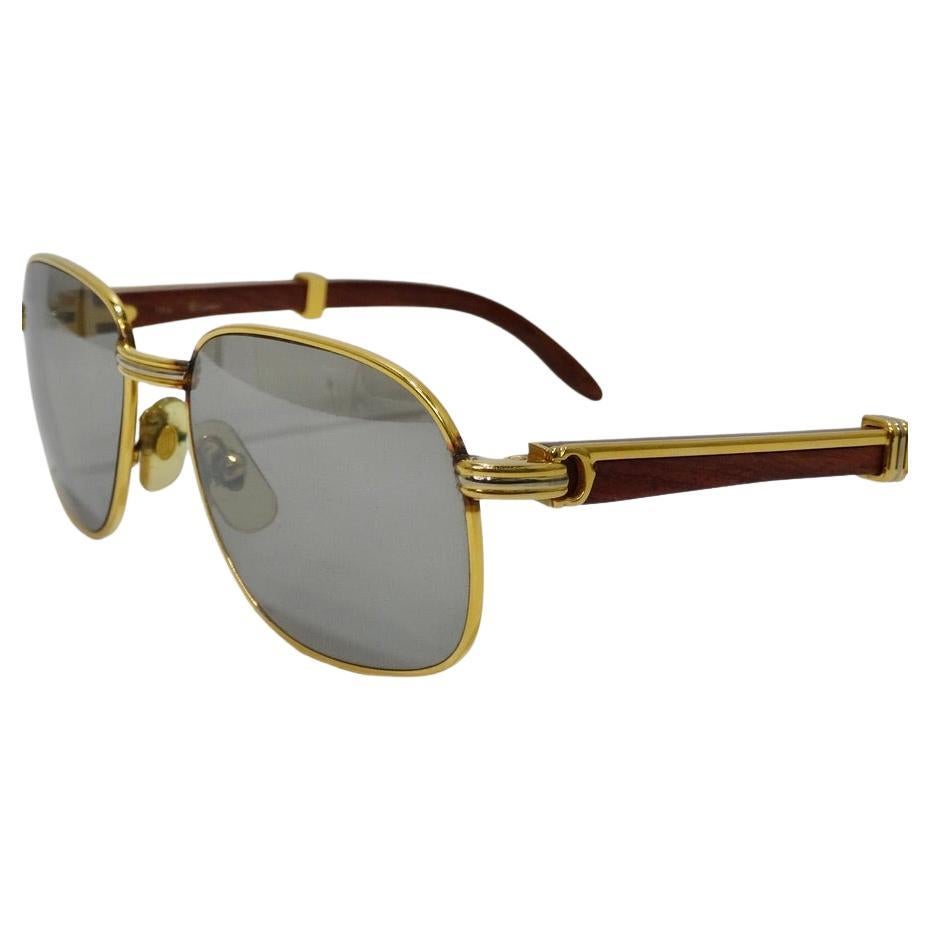 Timeless Cartier Wood Monceau 18K Gold Sunglasses circa 1990! Featuring the most gorgeous hardwood with gold accents on the temples and signature Cartier 'C' engravings. Tinted UV protectant lenses as well as nose pads ensure comfort and