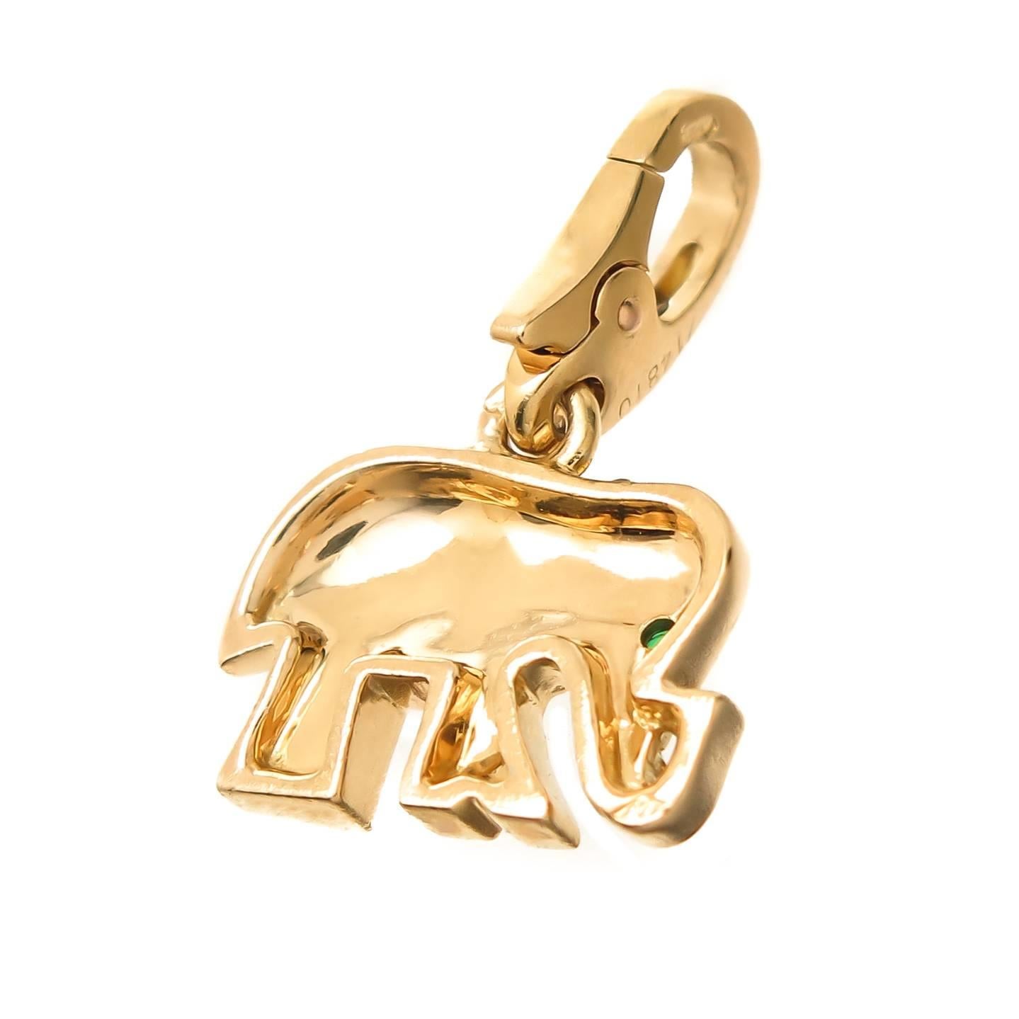 Circa 2000 Cartier 18K yellow Gold Elephant Charm,set with an Emerald Eye and Measuring 5/8 inch in length X 3/8 inch. Having a Lobster Claw lock so that the Charm can be easily taken on or off to be worn on a bracelet or a Necklace.