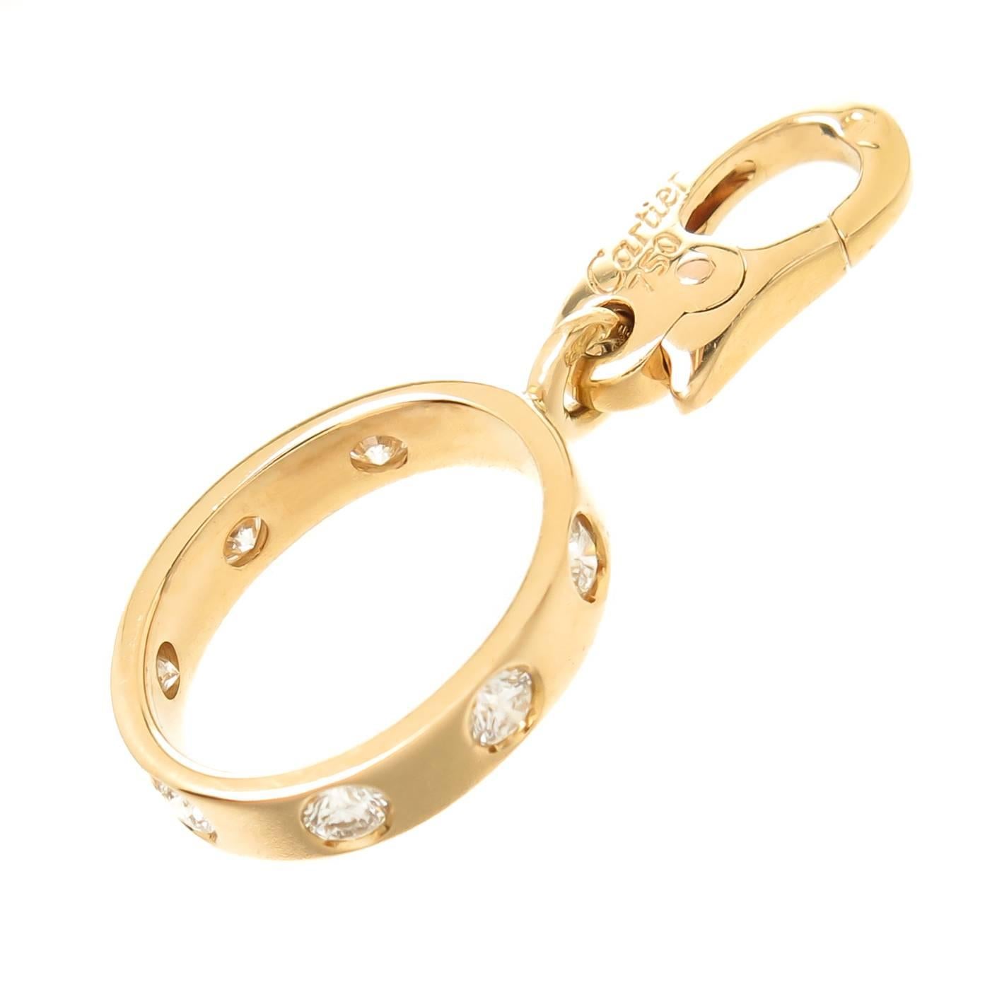 Circa 2000 Cartier Love Ring Charm, 18K Yellow Gold and set with Round Brilliant cut Diamonds totaling 1/4 Carat. The charm measures 1/2 inch in length X 7/16 inch.  Having a lobster Claw lock for easy take on and off so it can be worn on a bracelet