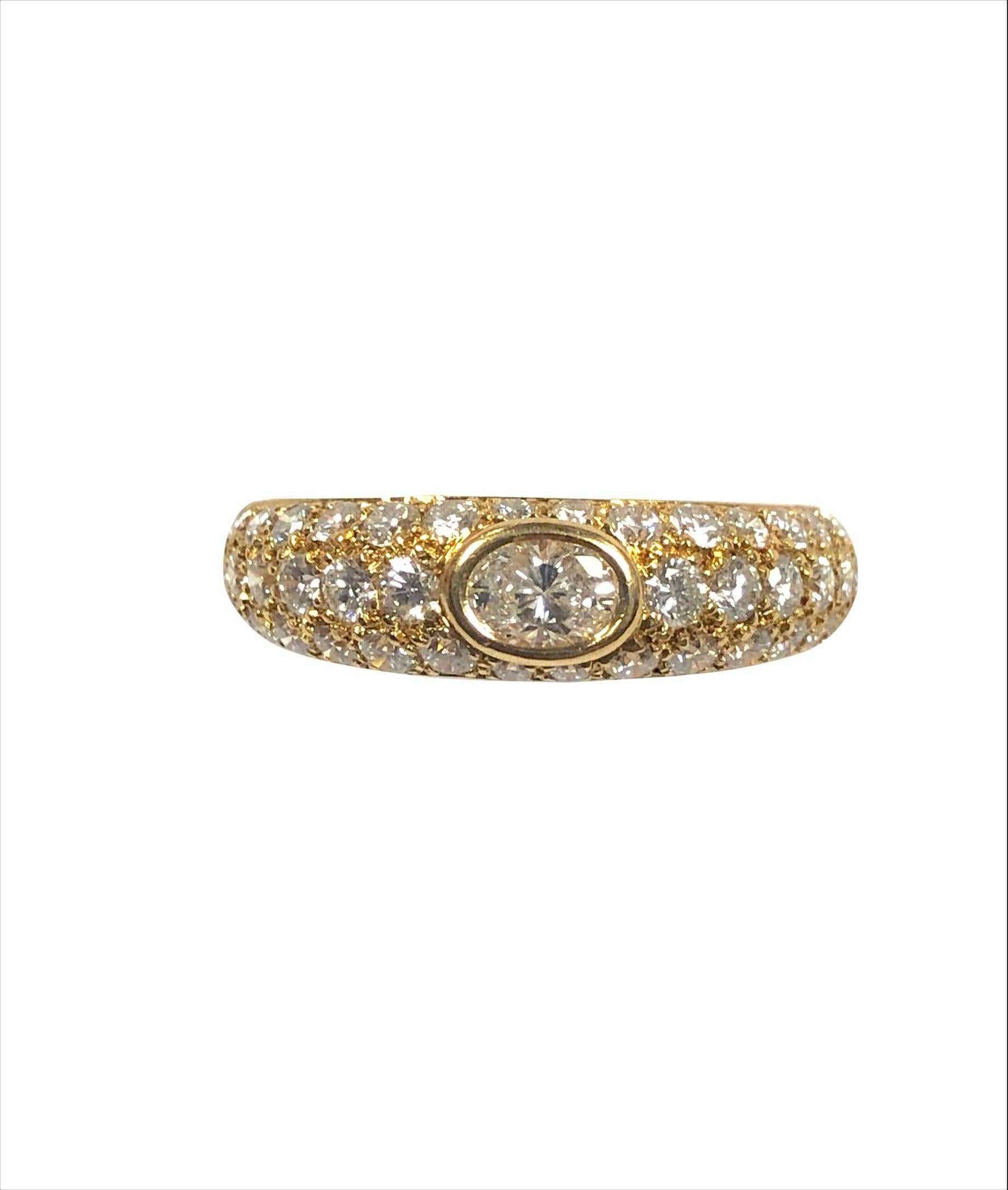 Circa 1990s Cartier 18K Yellow Gold Mimi Collection Ring, Centrally set with a 1/2 carat Oval Diamond and further set with Round Brilliant cut Diamonds totaling approximately 1.40 Carats. Measuring 7/8 inch in length across the top and 1/4 inch