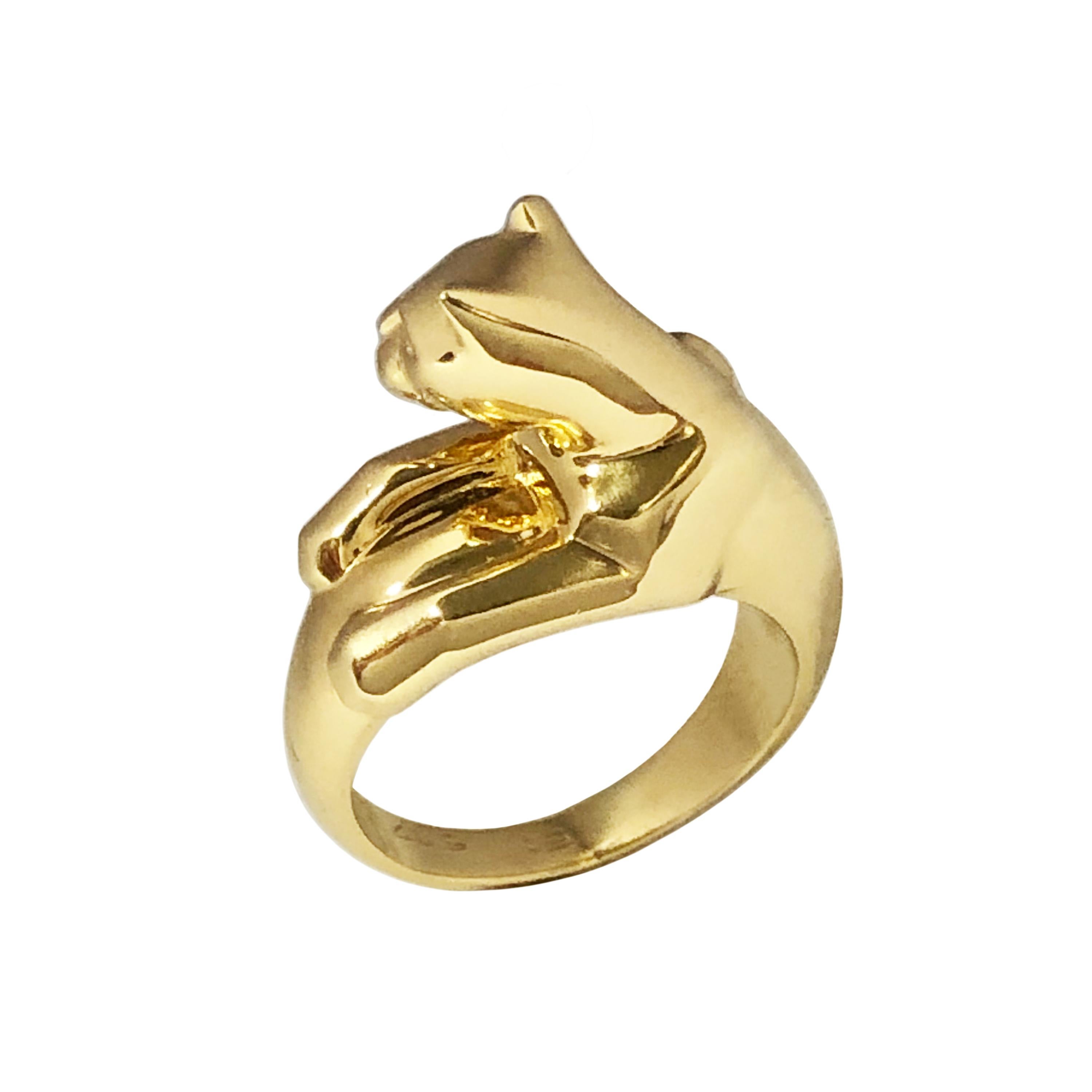 Circa 2000 Cartier Panther Ring, From the Iconic Panther Collection this is the full dimensional Panther on top of a tapering Band Ring, having Emerald Eyes and a Black Onyx Nose. Weighs 12 Grams and is a finger size 5 1/2 European size 51.