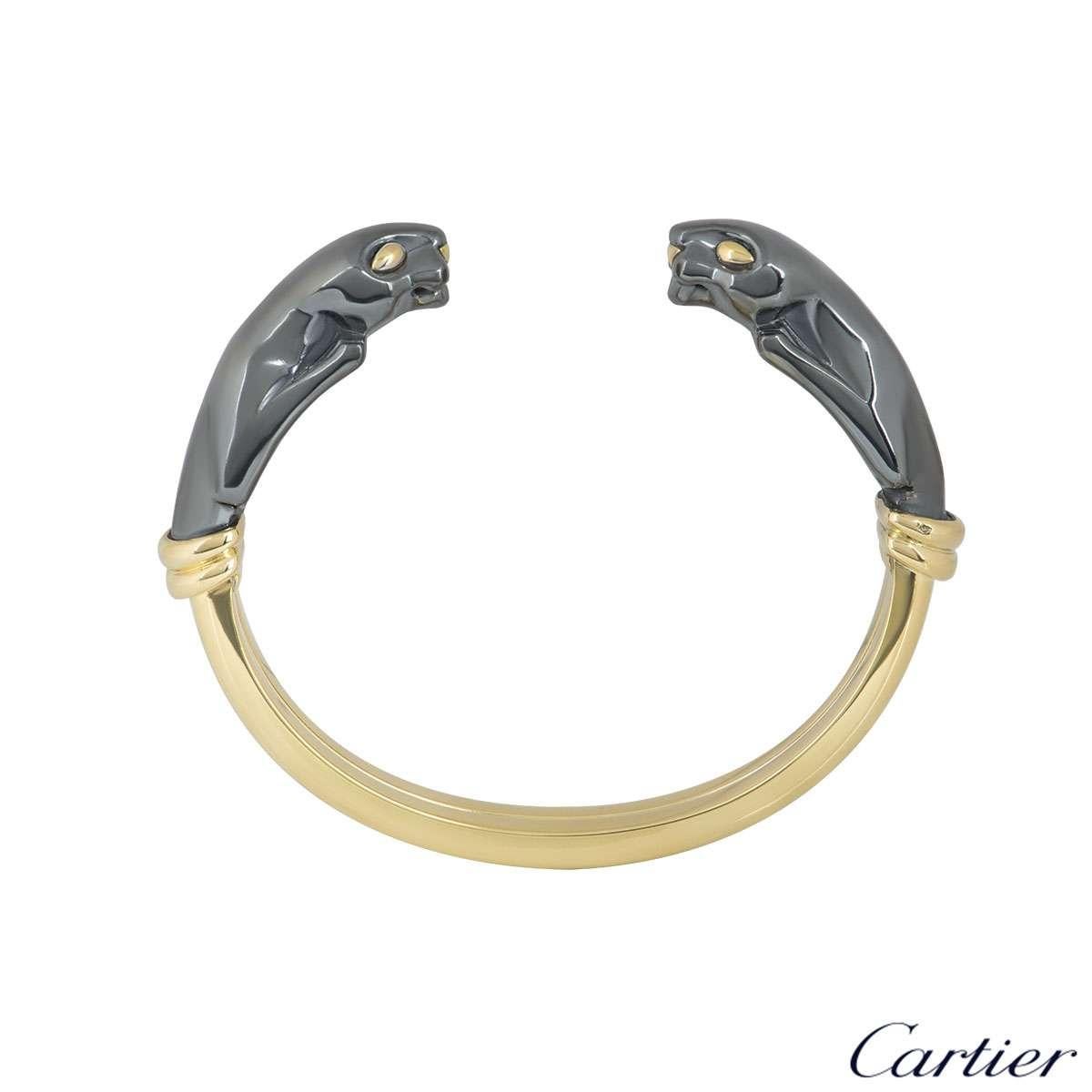 An 18k yellow gold and hematite cuff bracelet from the Panthere de Cartier collection. The bracelet is composed of 2 hematite Panther heads facing each other, joined together by the polished yellow gold cuff. The bracelet would fit a wrist size of