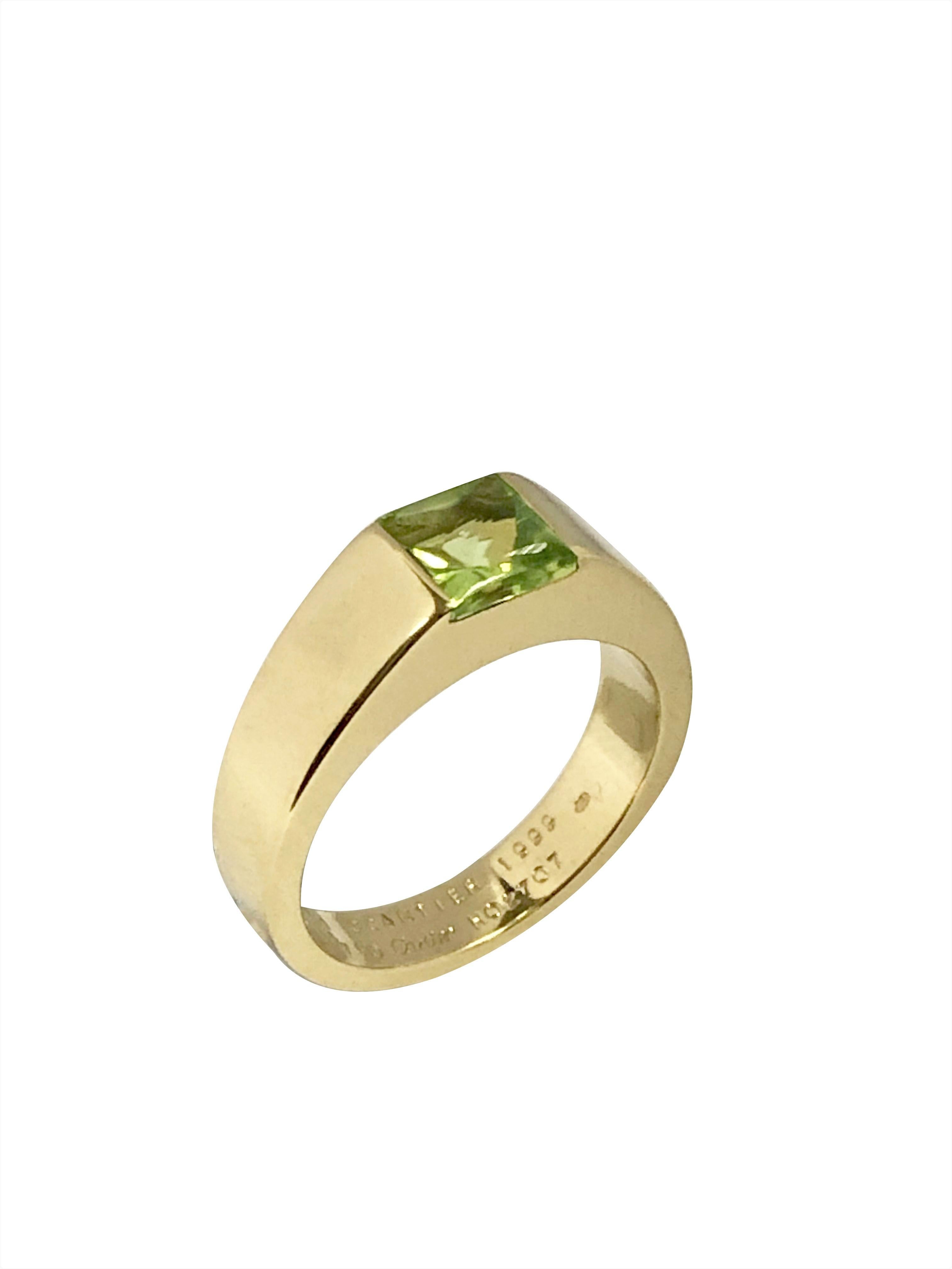 Circa 2010 Cartier Tank collection 18K Yellow Gold Ring, centrally set with a Square Cushion Cabochon top and faceted bottom Fine color Peridot, finger size 5 3/4, comes in the original Cartier Presentation box. 