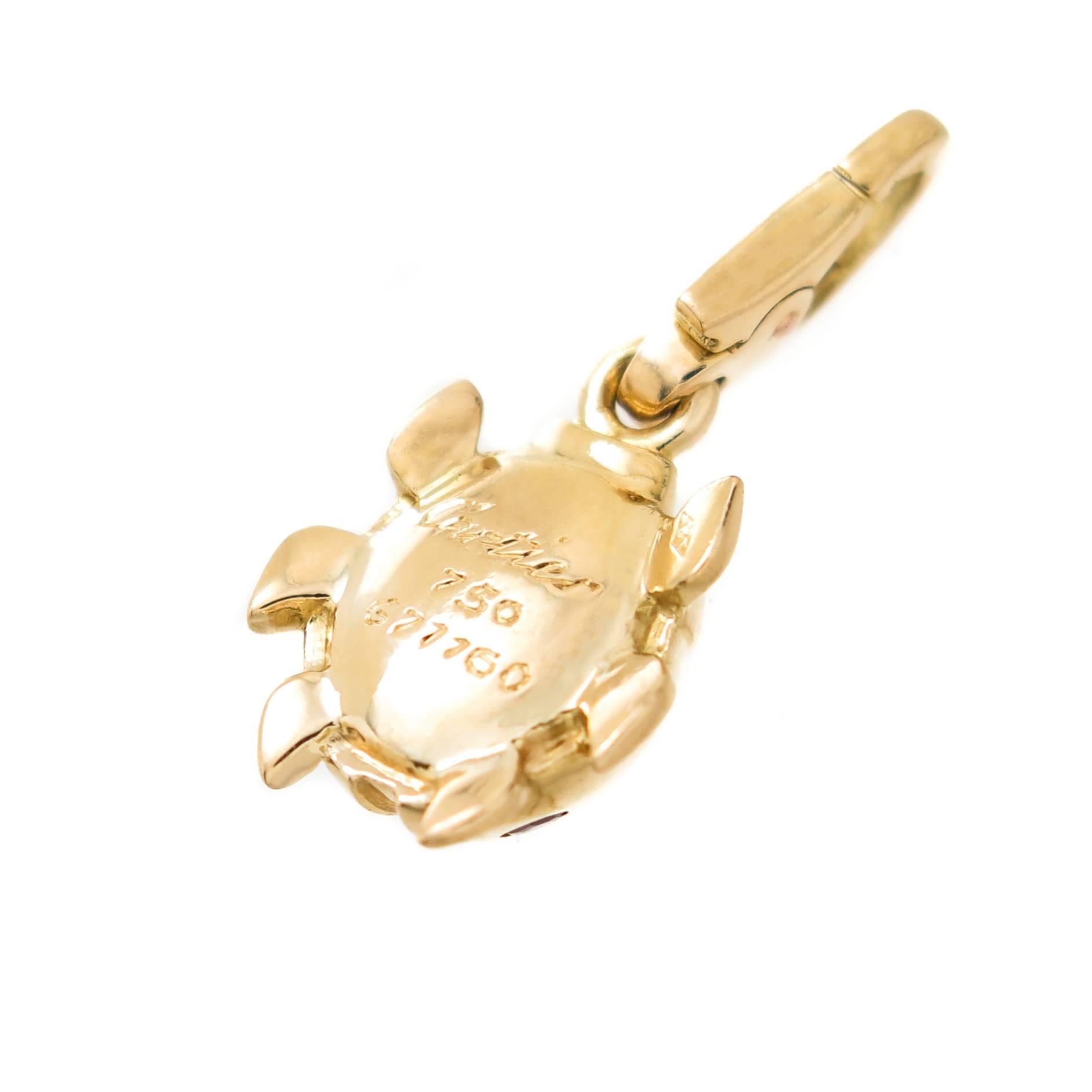 Circa 2000 Cartier 18K Yellow Gold Lady Bug Charm, measuring 1/2 inch in length X 3/8 inch and set with numerous Round Rubies. Having a lobster Claw Clasp so the Charm can be easily taken on or off to be worn on a Bracelet or a Necklace. 