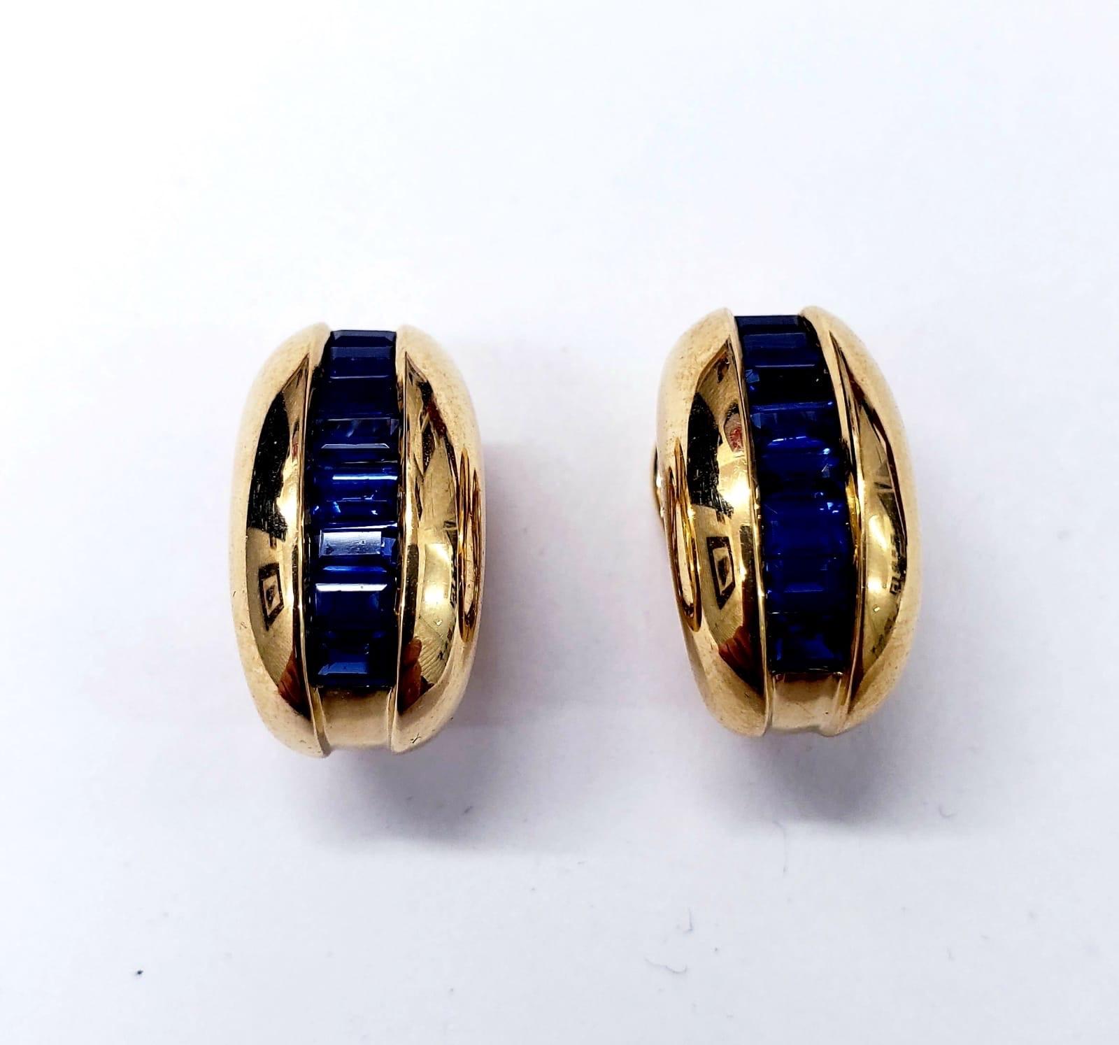 Cartier Yellow Gold Bombe Bean 1.50ct Blue Sapphire Earrings. The total carats weights approx 1.50ct. The earrings are made of 18k solid yellow gold. The earrings weight 12.8 grams. Features post and hinge clip fittings. Measures 10.3mm X 18mm.