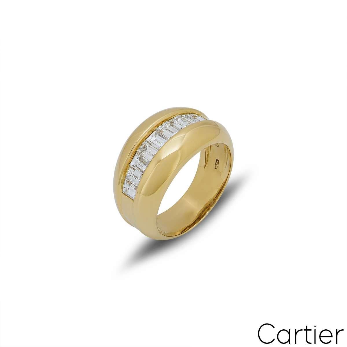 An 18k yellow gold Bombe style ring by Cartier. The ring has 9 baguette cut diamonds in a chanel setting through the centre, with a total weight of approximately 0.75ct. The ring measures 11mm in width, is a size UK O, US 7 and EU 54 and has a gross