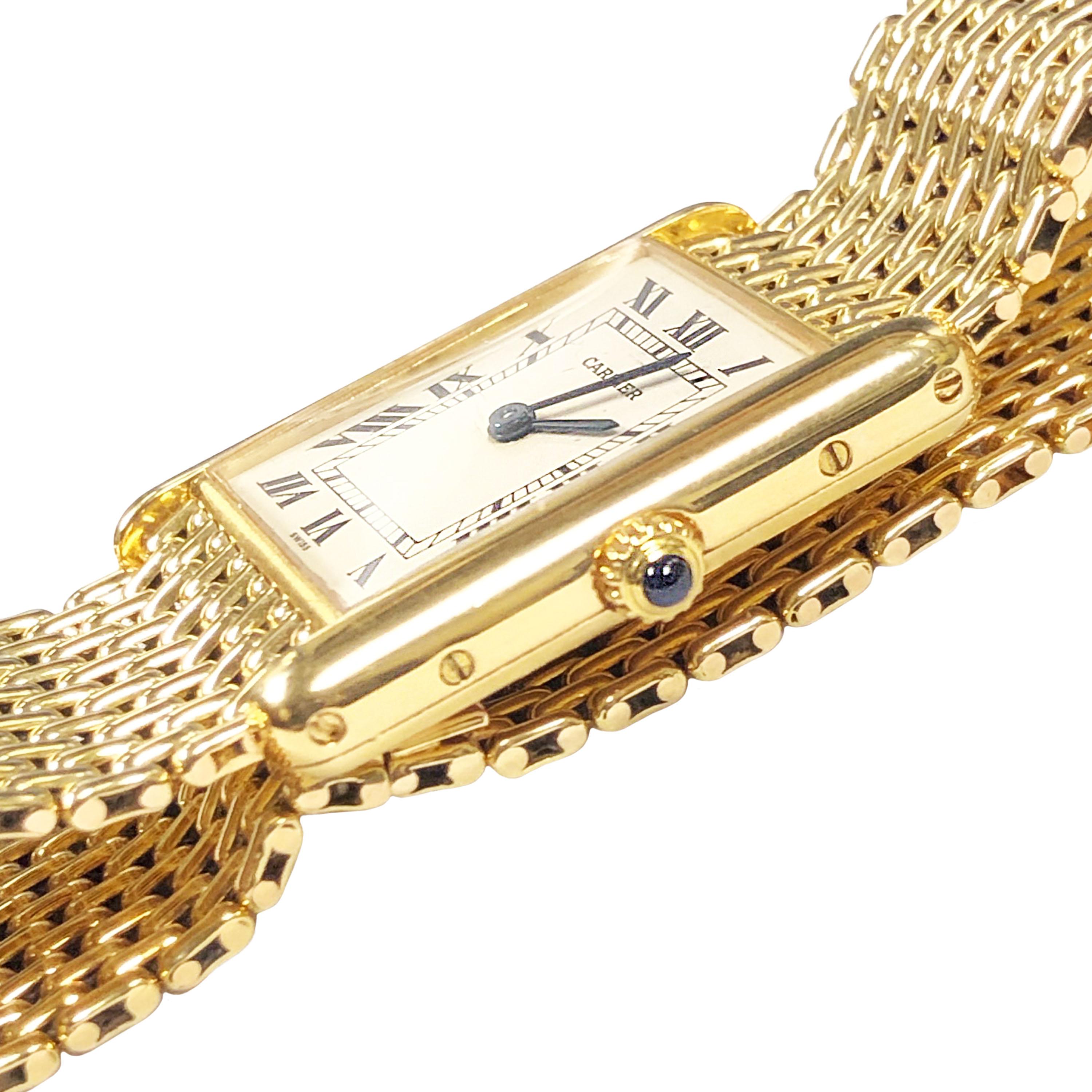Circa 2000 Cartier Classic Tank Wrist Watch, 30 X 24 MM  18k Yellow Gold 2 piece case. Quartz movement, White Dial with Black Roman Numerals and a Sapphire Crown. 11/16 inch wide 18K yellow Gold Woven Link Bracelet with Deployment buckle. Watch