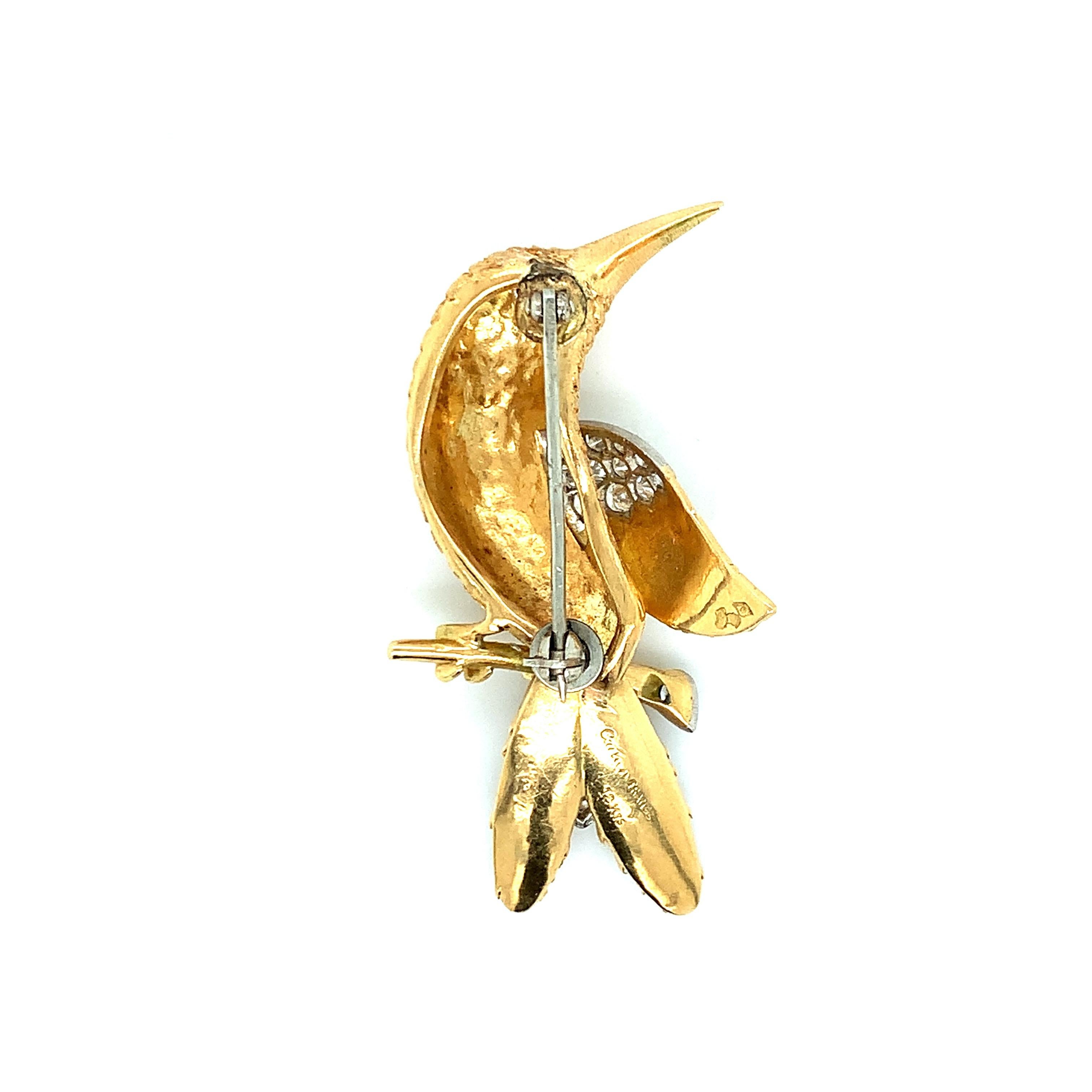 Cartier 18 karat yellow gold hummingbird brooch, consisting of 16 brilliant cut diamonds weighing approximately 0.80 carat and one sapphire for the eye. Marked: Cartier / France / 18kts. Total weight: 13.1 grams. Width: 2.5 cm. Length: 4.7 cm. 
